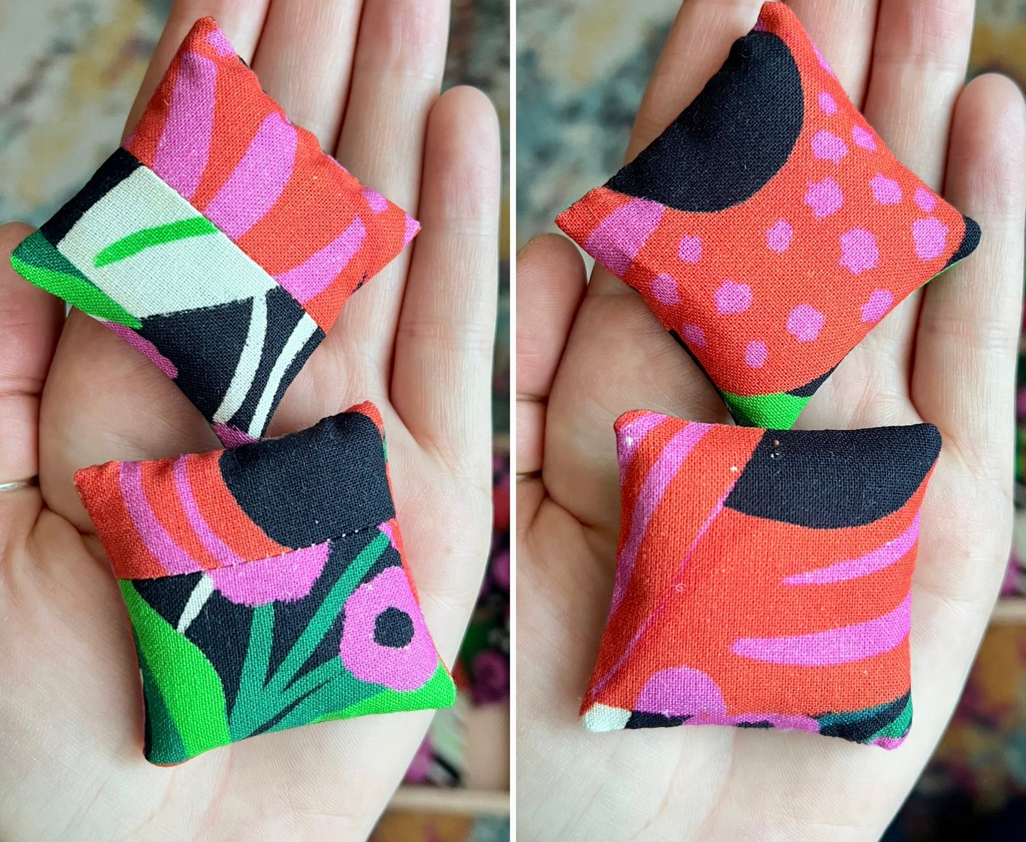 Colorful fabric pillows held in a hand with a blurred background
