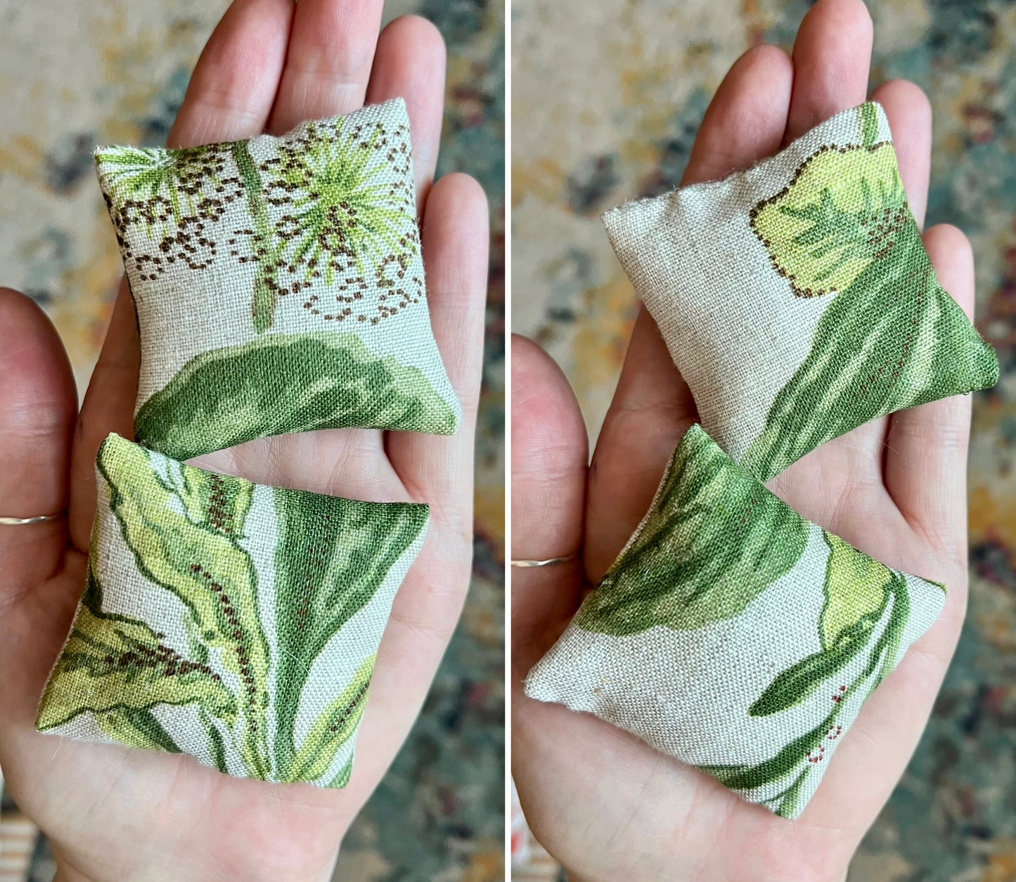 Two fabric pillows with green leaf patterns held in hands against a blurred background.