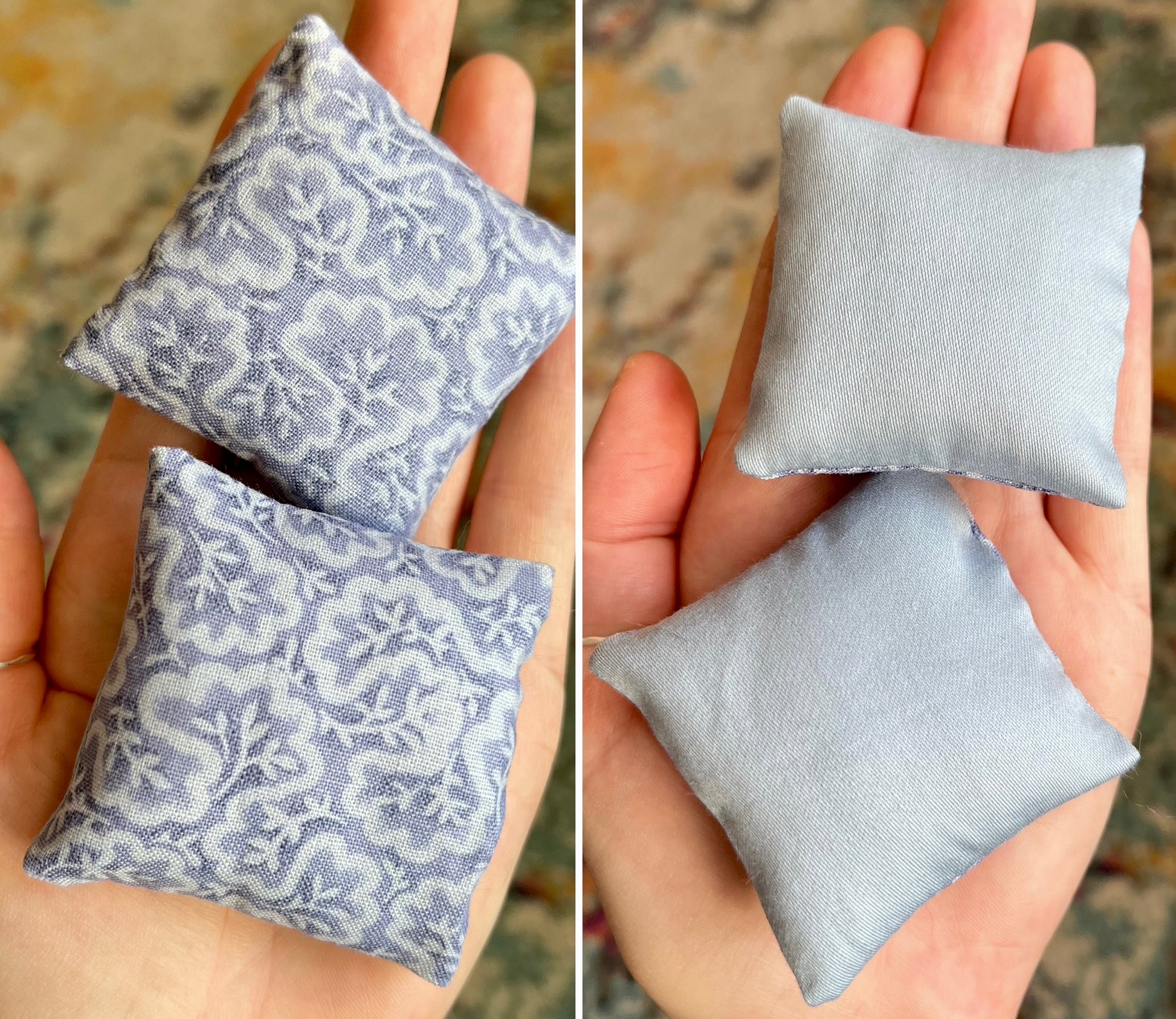 Two small fabric pillows, one with a pattern and one plain, held in hands against a blurred background.