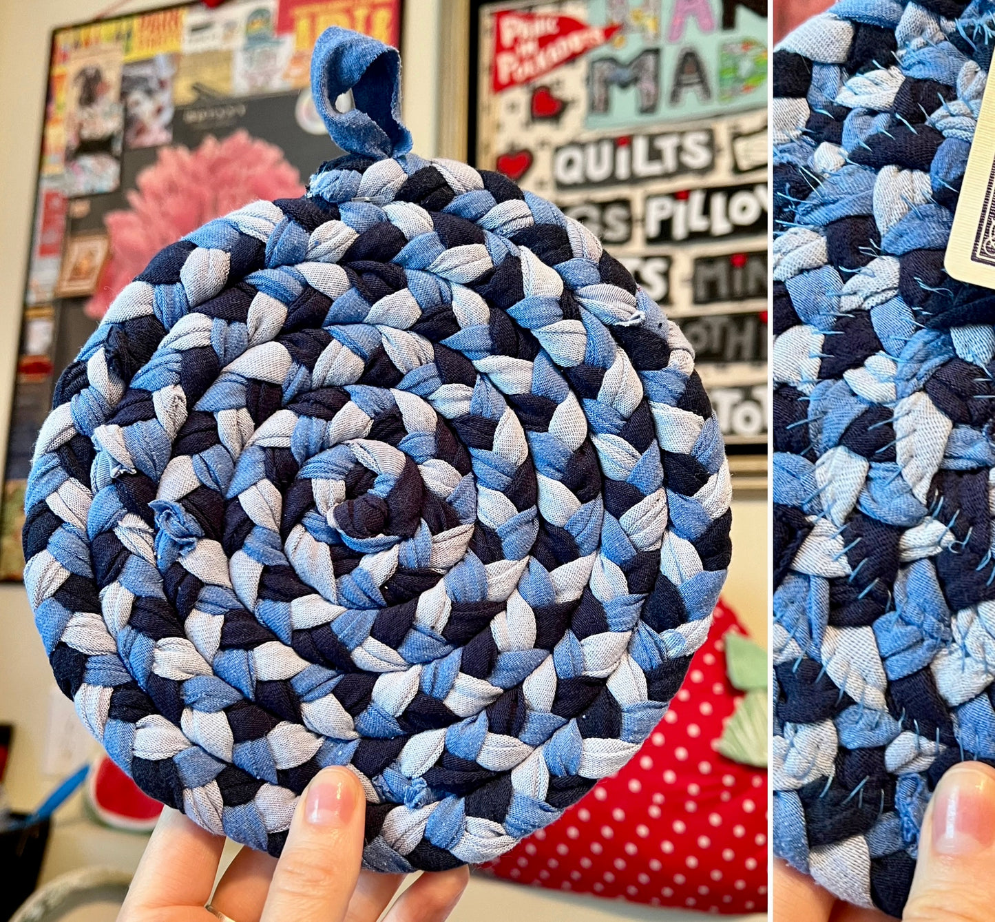A handmade braided fabric trivet or coaster in a spiral pattern of navy, medium blue, and light blue denim, held by a hand in front of a quilted wall background.