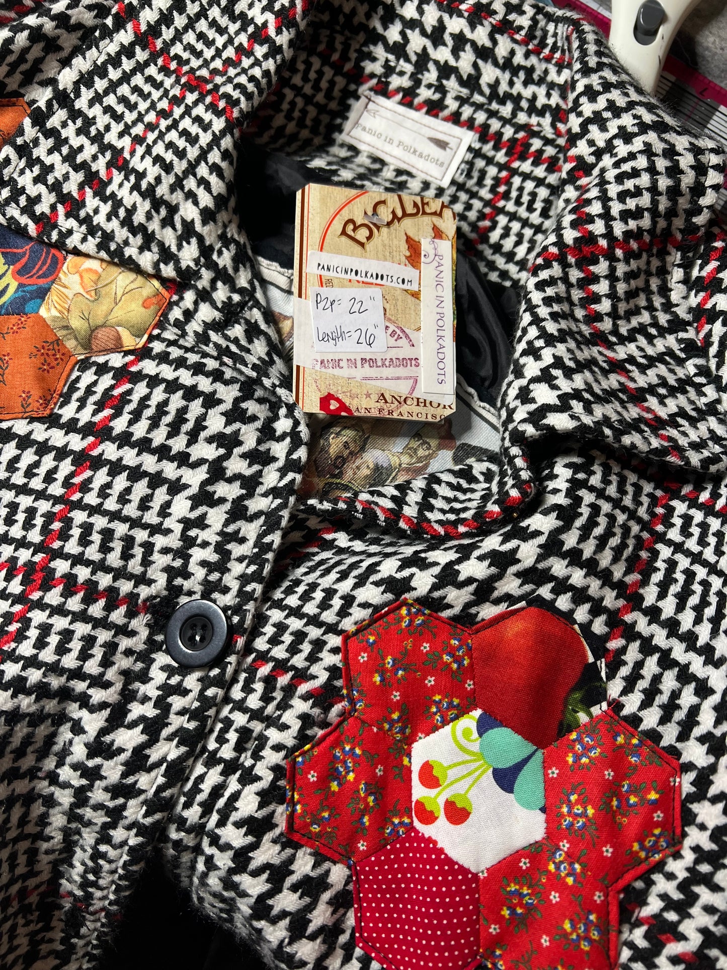 Close-up of a patterned fabric with decorative patches and buttons.