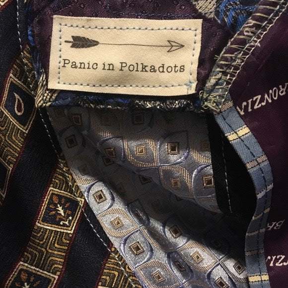 Blue and gold necktie skirt, closeup of Panic in Polkadots tag