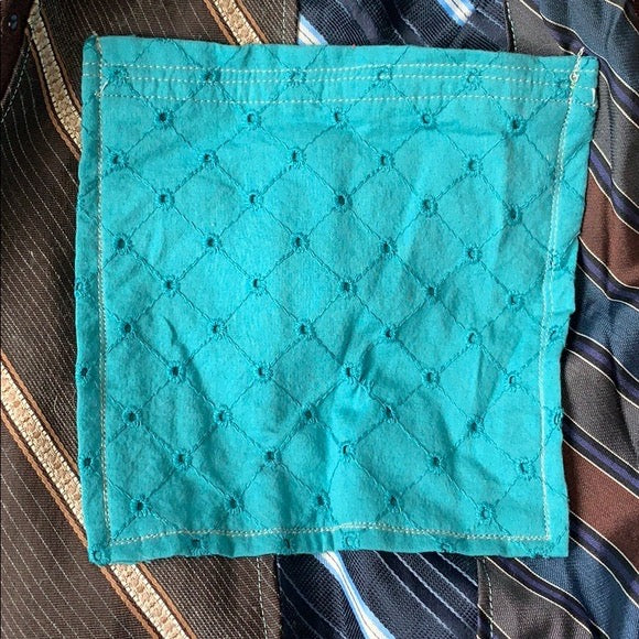 Brown and Blue necktie skirt, closeup of eyelet pocket in teal