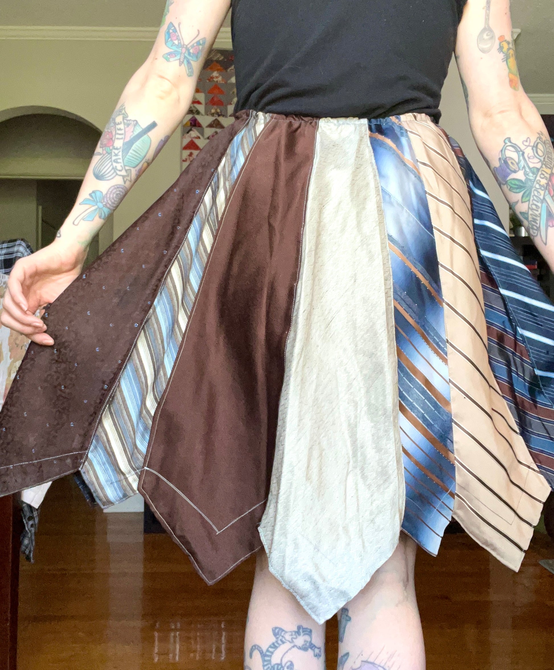 Brown and Blue necktie skirt, back view, modeled and held out to the side