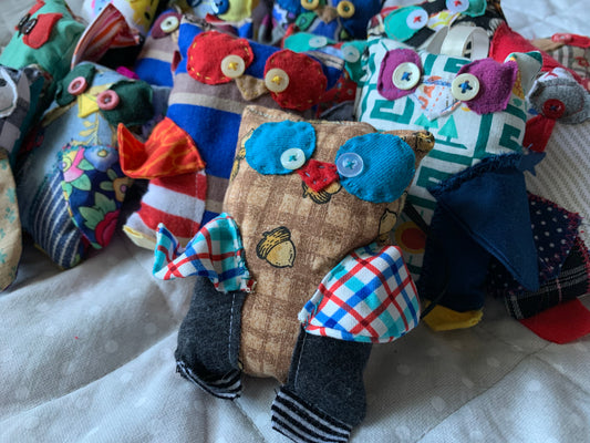 closeup group shot, side view, of cute mini owls