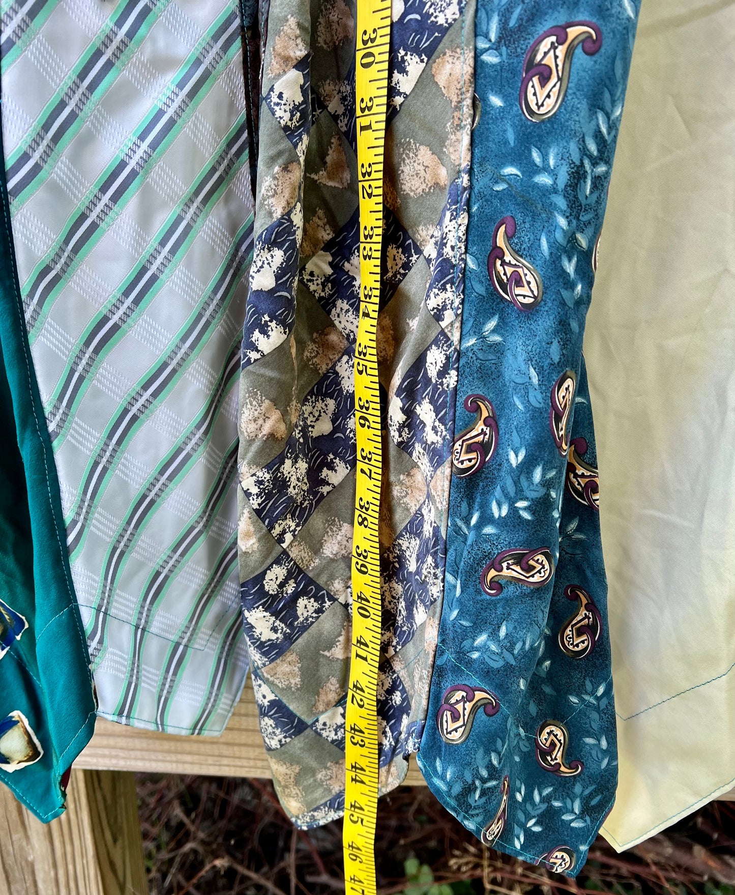 Blue/green shirtdress, with measuring tape down front, showing 46 inches.