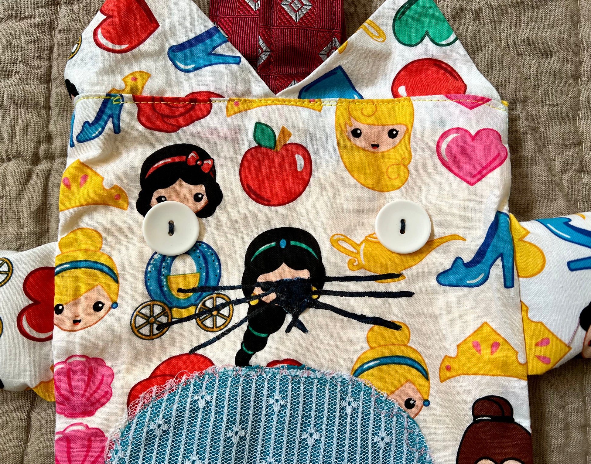 Closeup of kitty tote bag, showing off button eyes and hand-painted mouth and nose