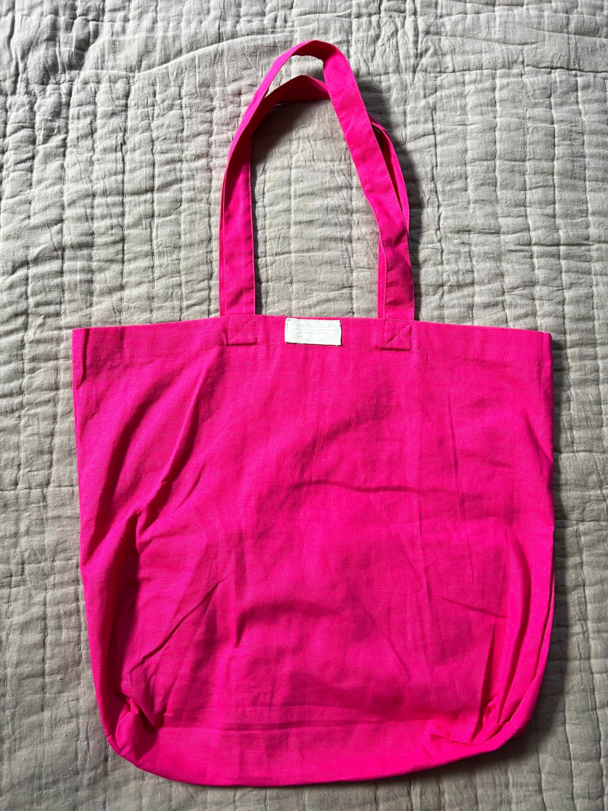 backview of pink tote bag, with Panic in Polkadots label