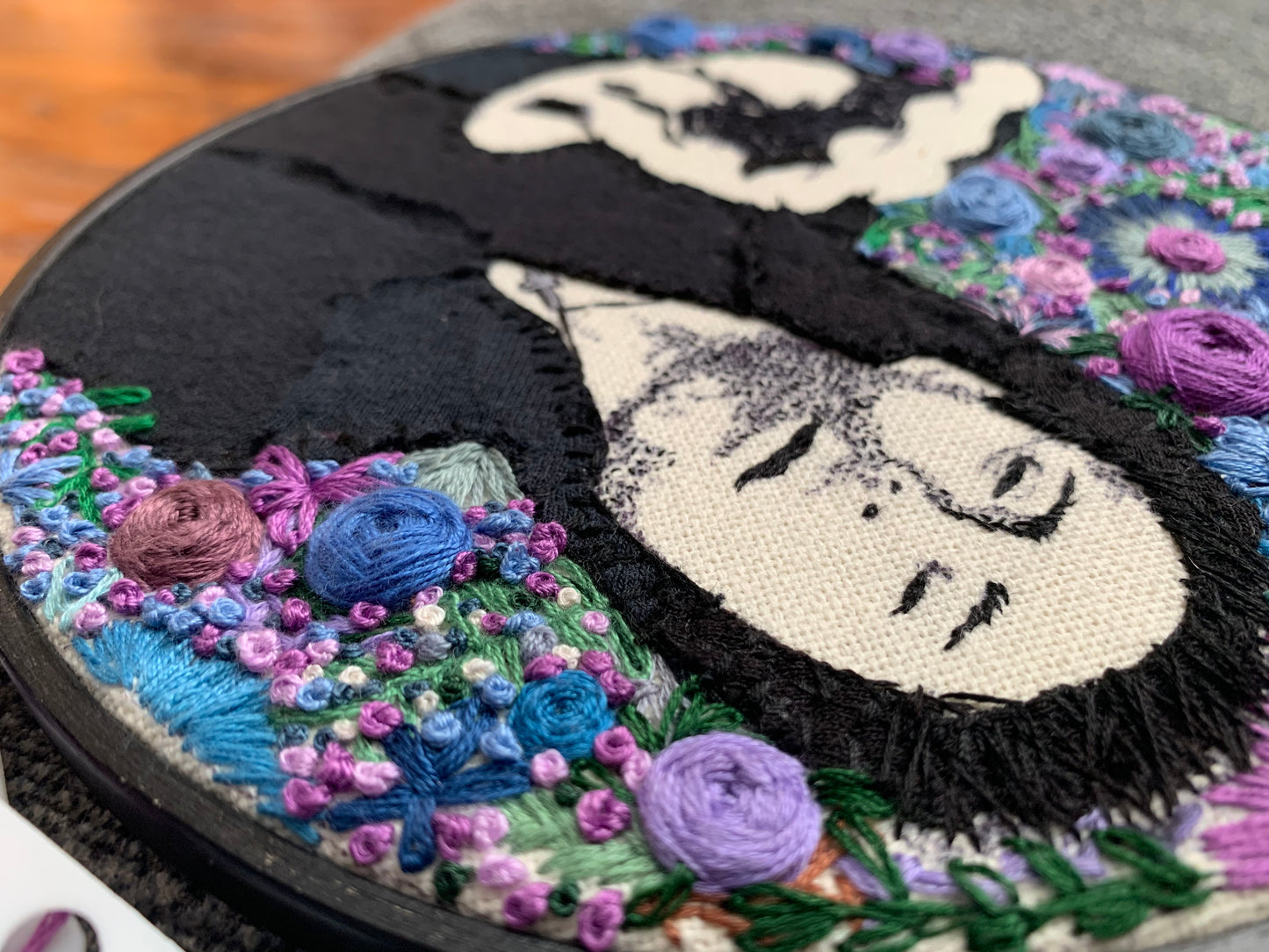closeup side view of Davey Havok embroidery hoop art
