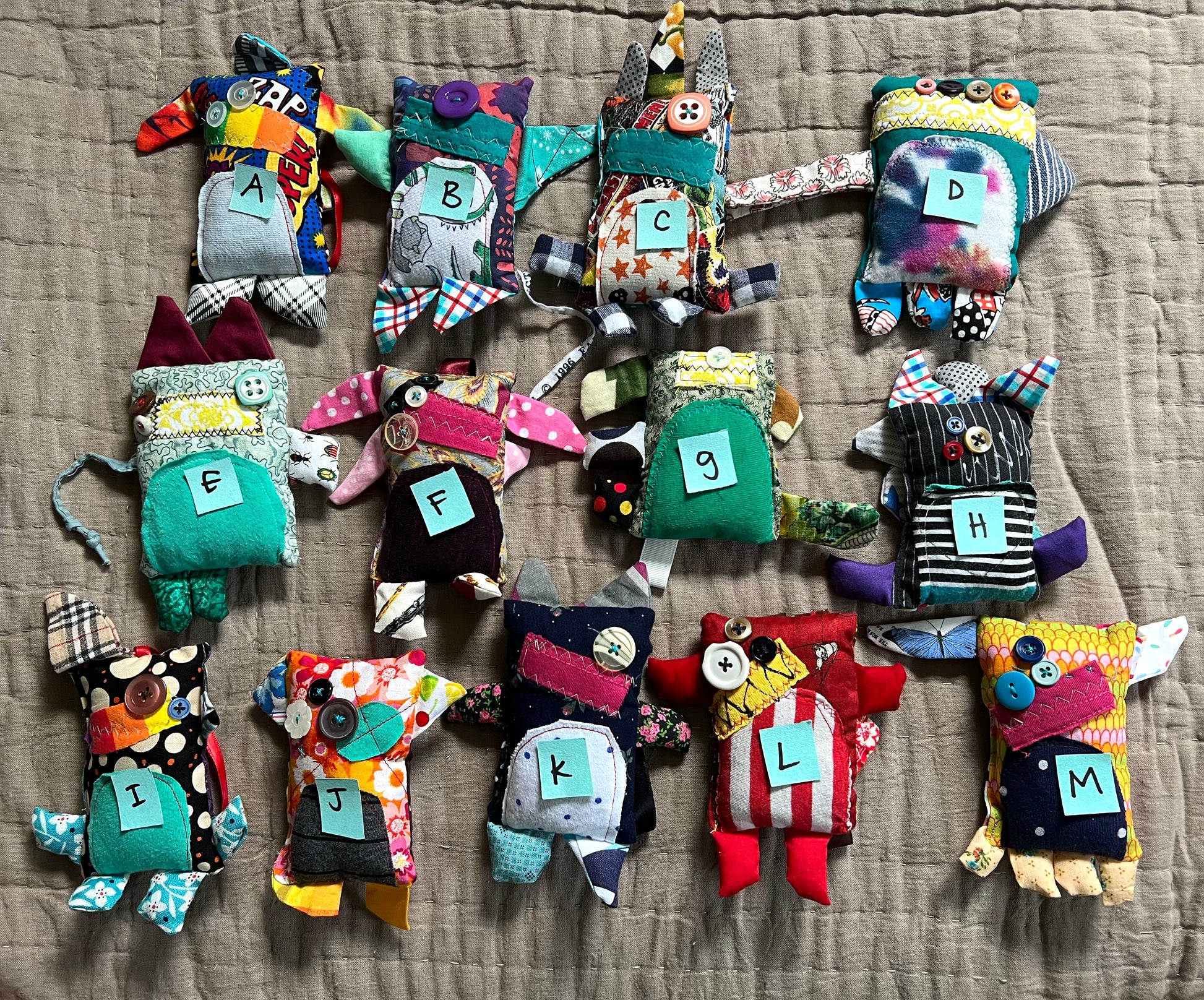 front view of mini monster keychain ornaments, with letters on top for easy selection.