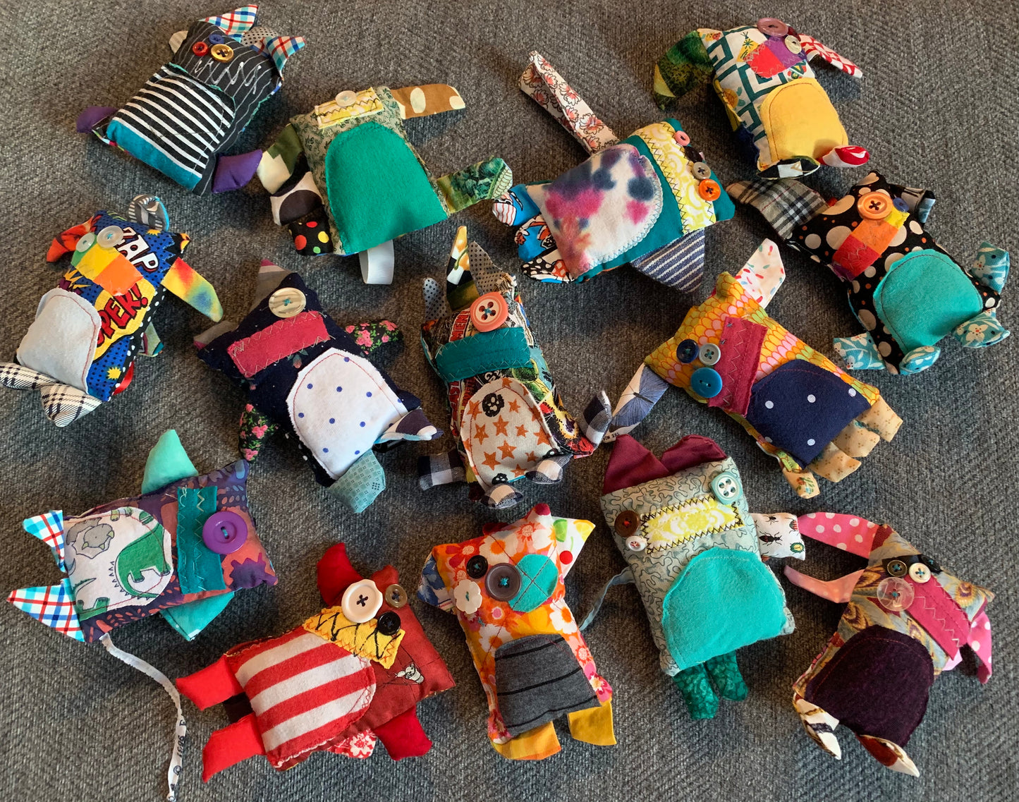 mini monstr keychain ornaments, in a group, aerial view flat lay against a grey background