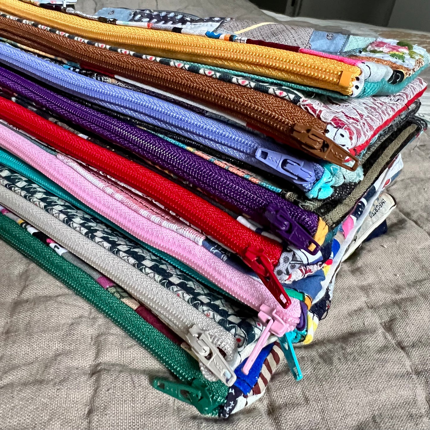 stack of zipper pouches, closeup on the colorful zippers