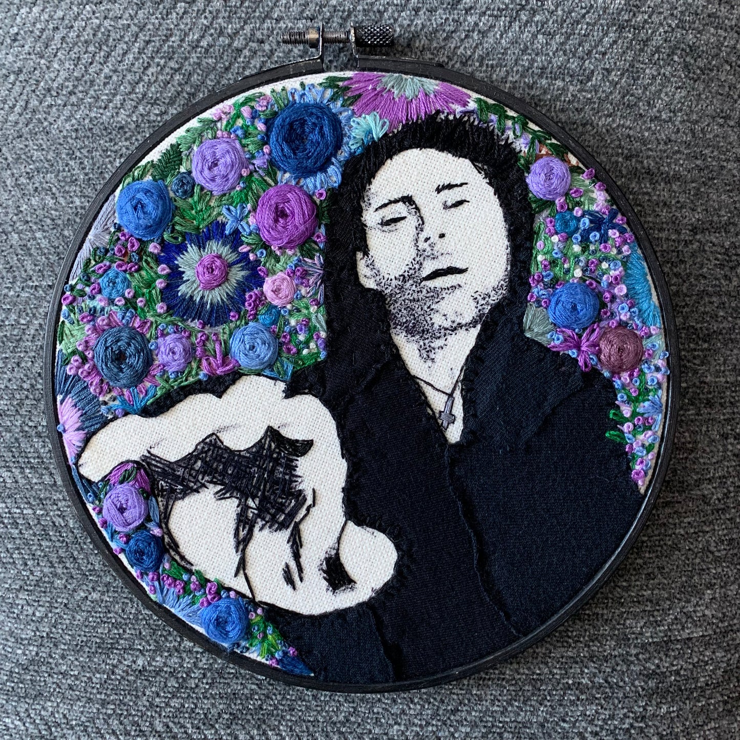 Davey Havok of AFI, embroidery hoop, handmade. Aerial view against a grey textured background