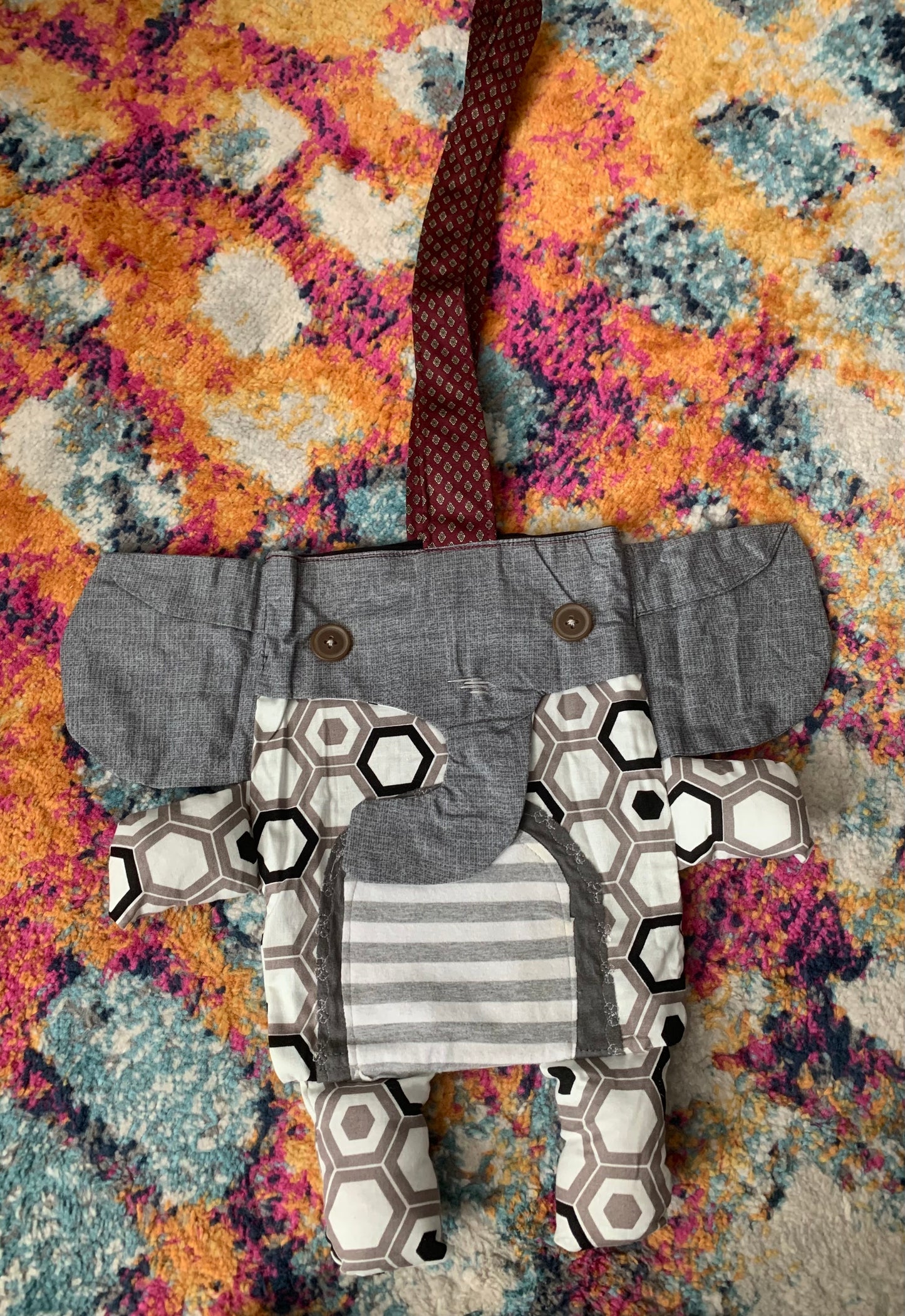 elephant tote bag, with necktie strap. Grey trunk and ears, hexagon print body, with grey striped tummy.