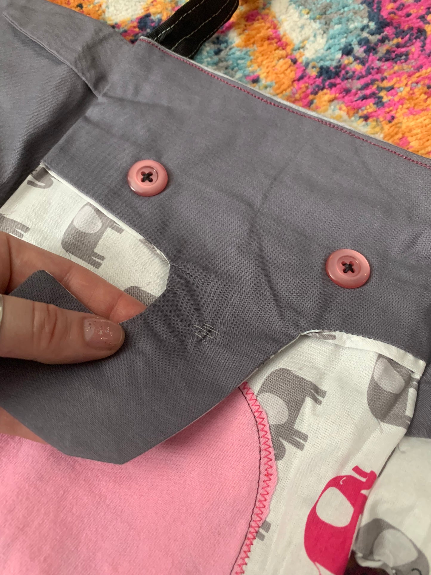 closeup of elephant tote bag, a hand is gently holding the trunk