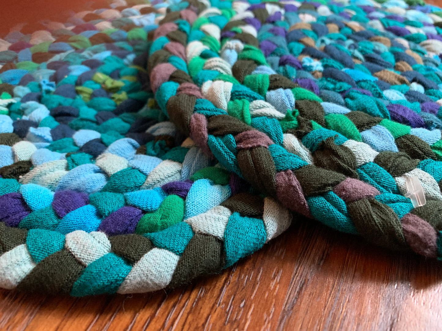 Close up, side view, showing detail in edge of trivets on wood surface.