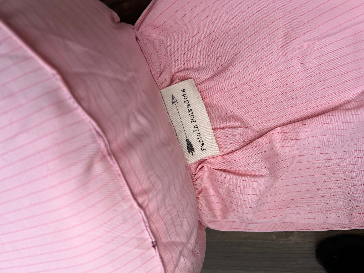 "Panic in Polkadots" label, closeup view, as it is shown sewn into the "wrap" part of candy pillow