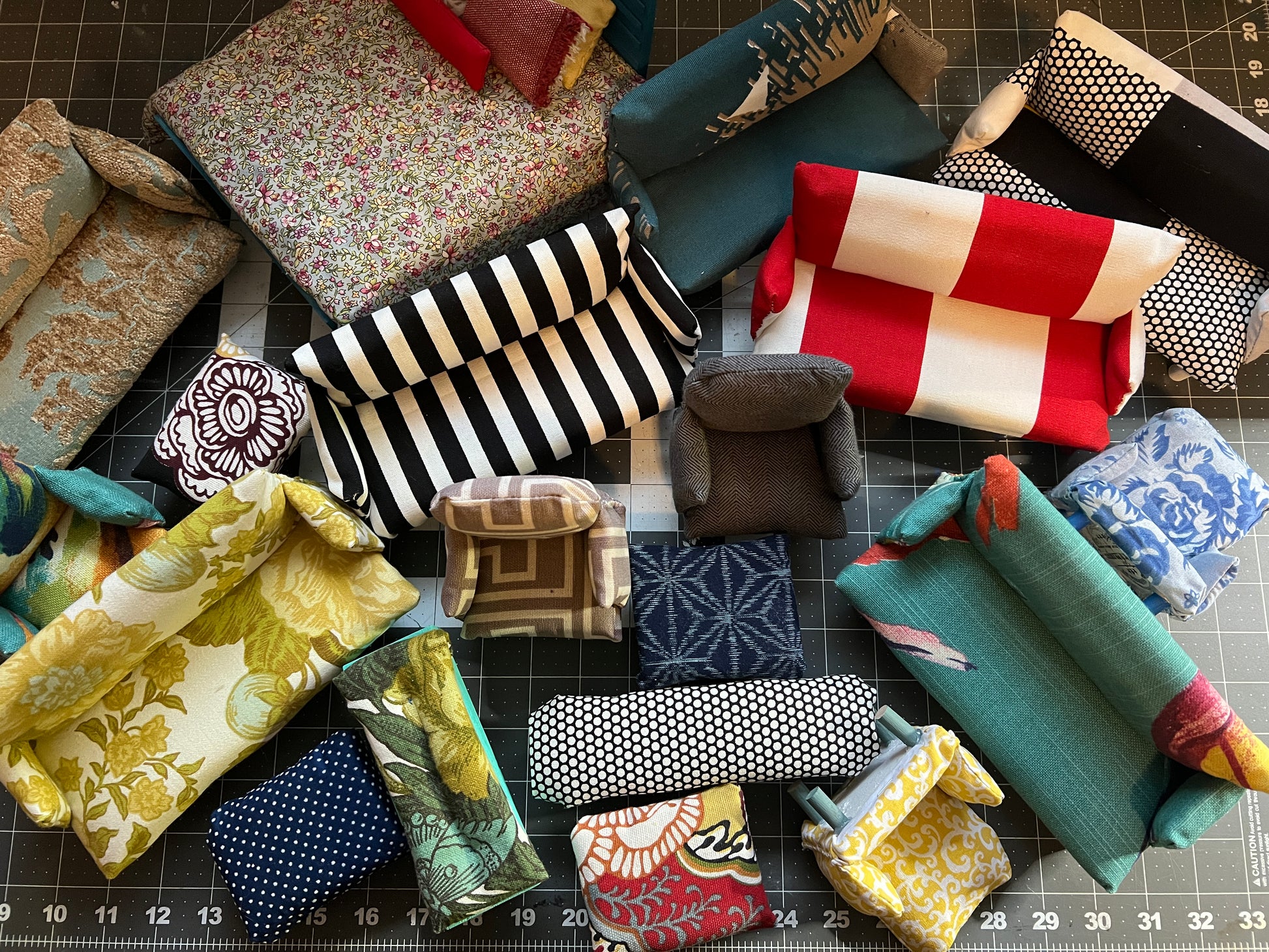 birds eye view of a collection of dollhouse chairs, couches, and ottomans