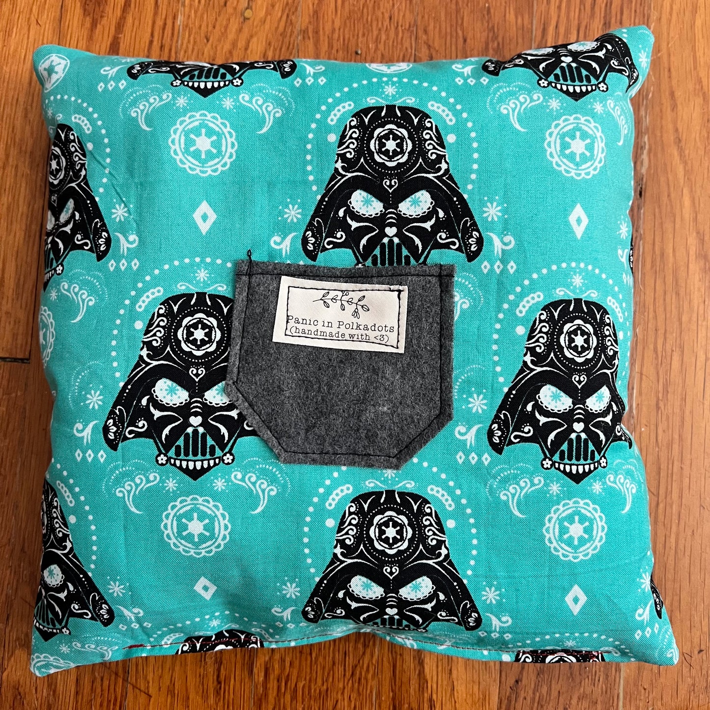 back view of pillow, with Darth Vader print, and a felt grey pocket with Panic label