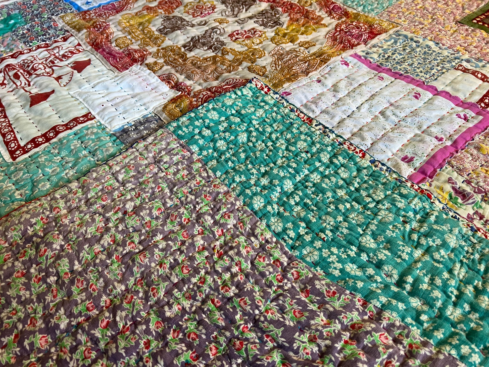 a back corner of the quilt has been folded over to the front. The back and front match so well, it basically blends in