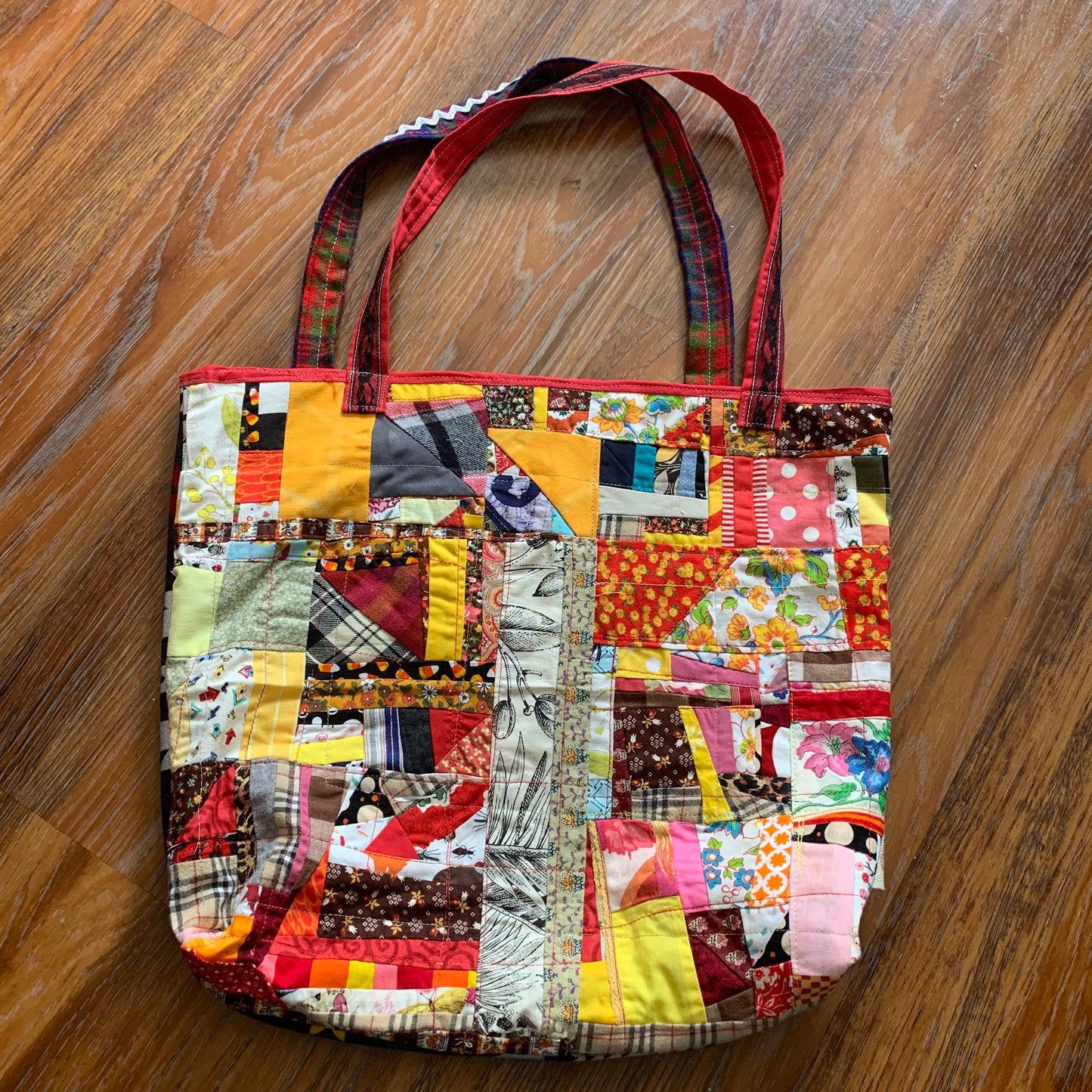 aerial view of autumn orange tote bag, on a wood floor background