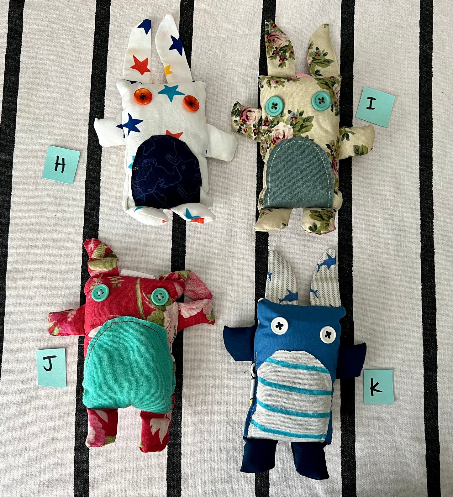 front view of mini animals with letters H I J K next to each one.