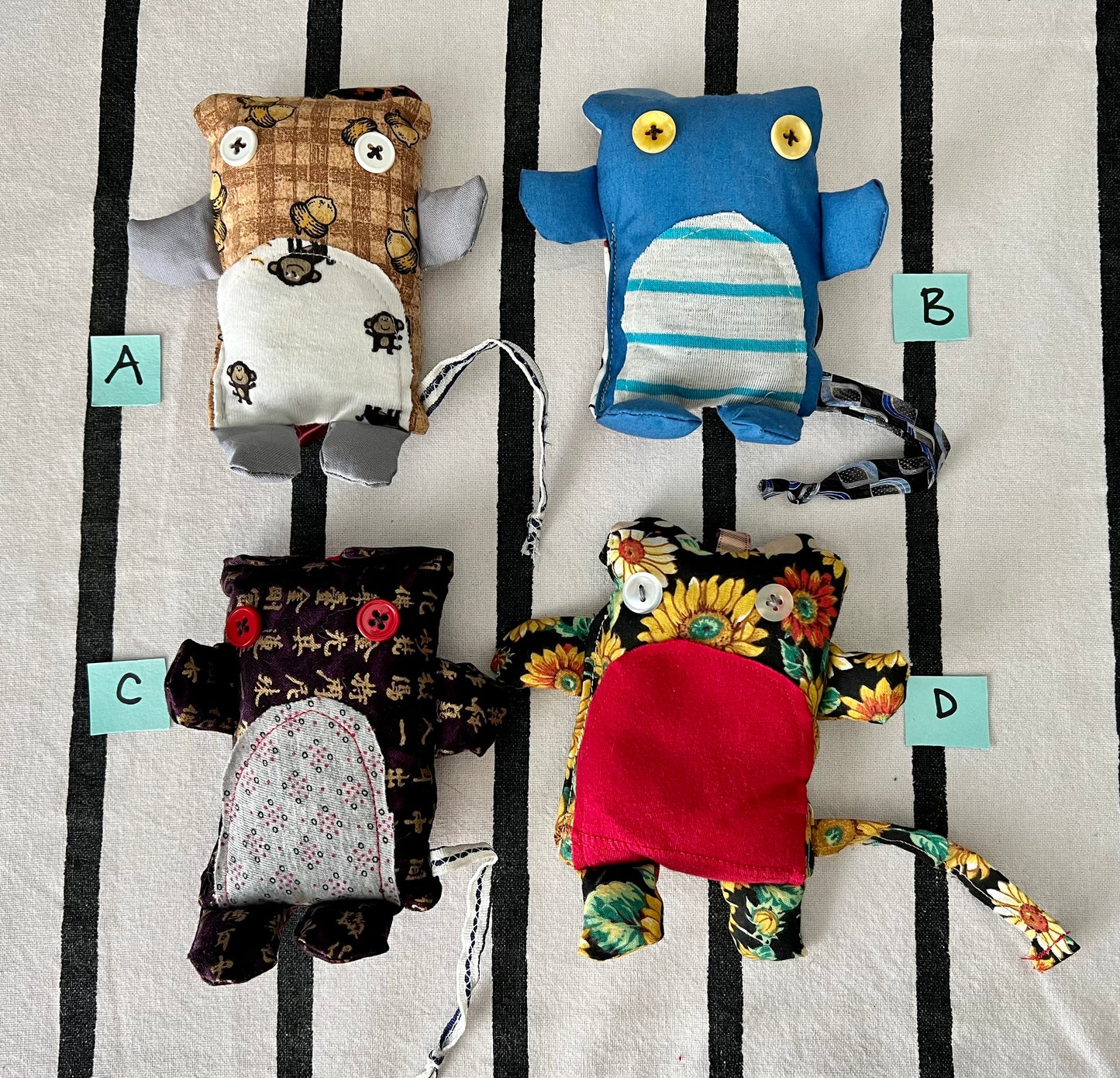 front view of mini animals with letters A B C D next to each one.