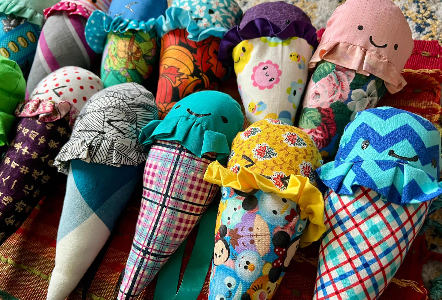Colorful fabric cones with various patterns and designs on a textured surface