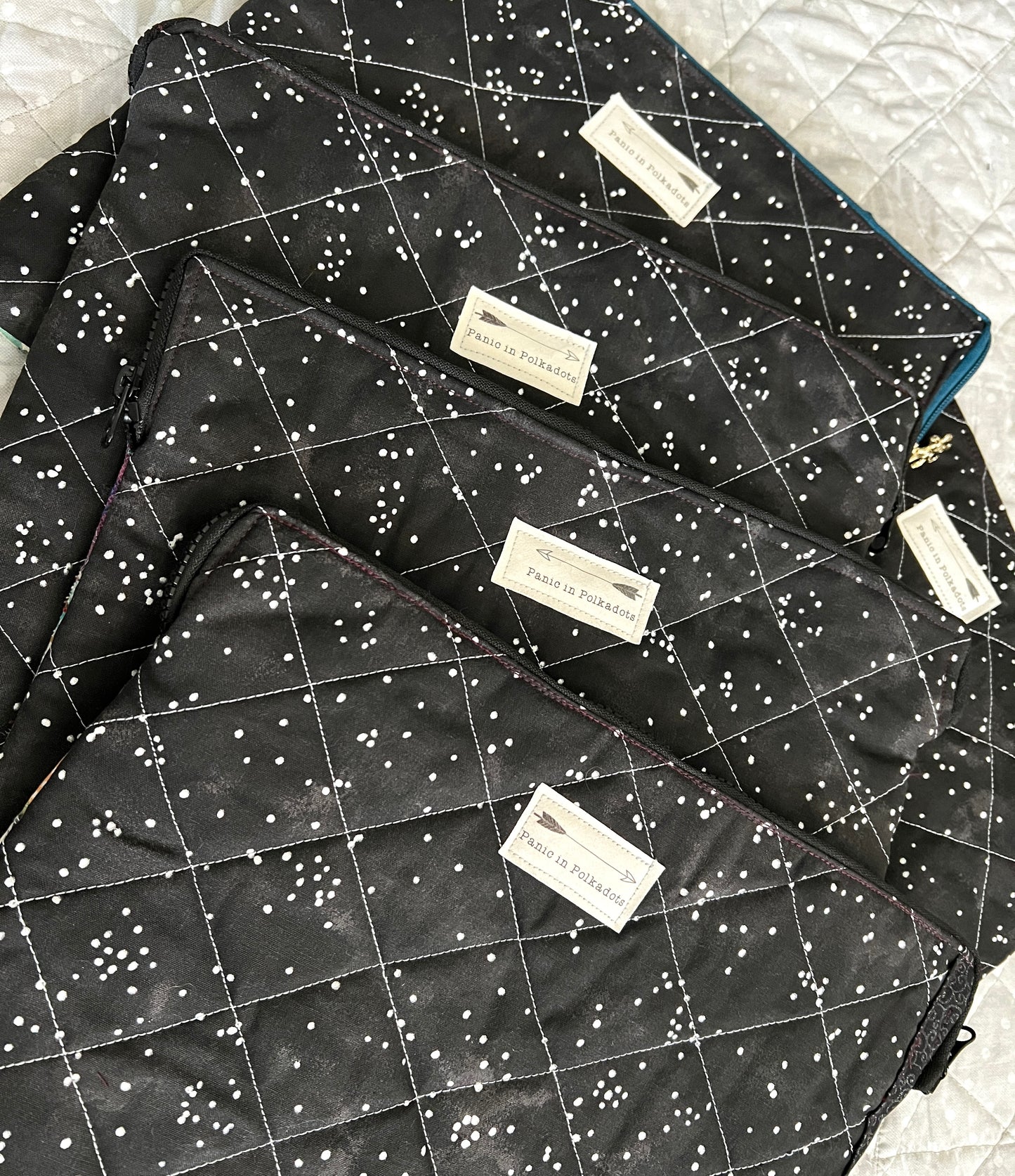 Assortment of ipad cases, showing the backs, where each has a Panic in Polkadots label
