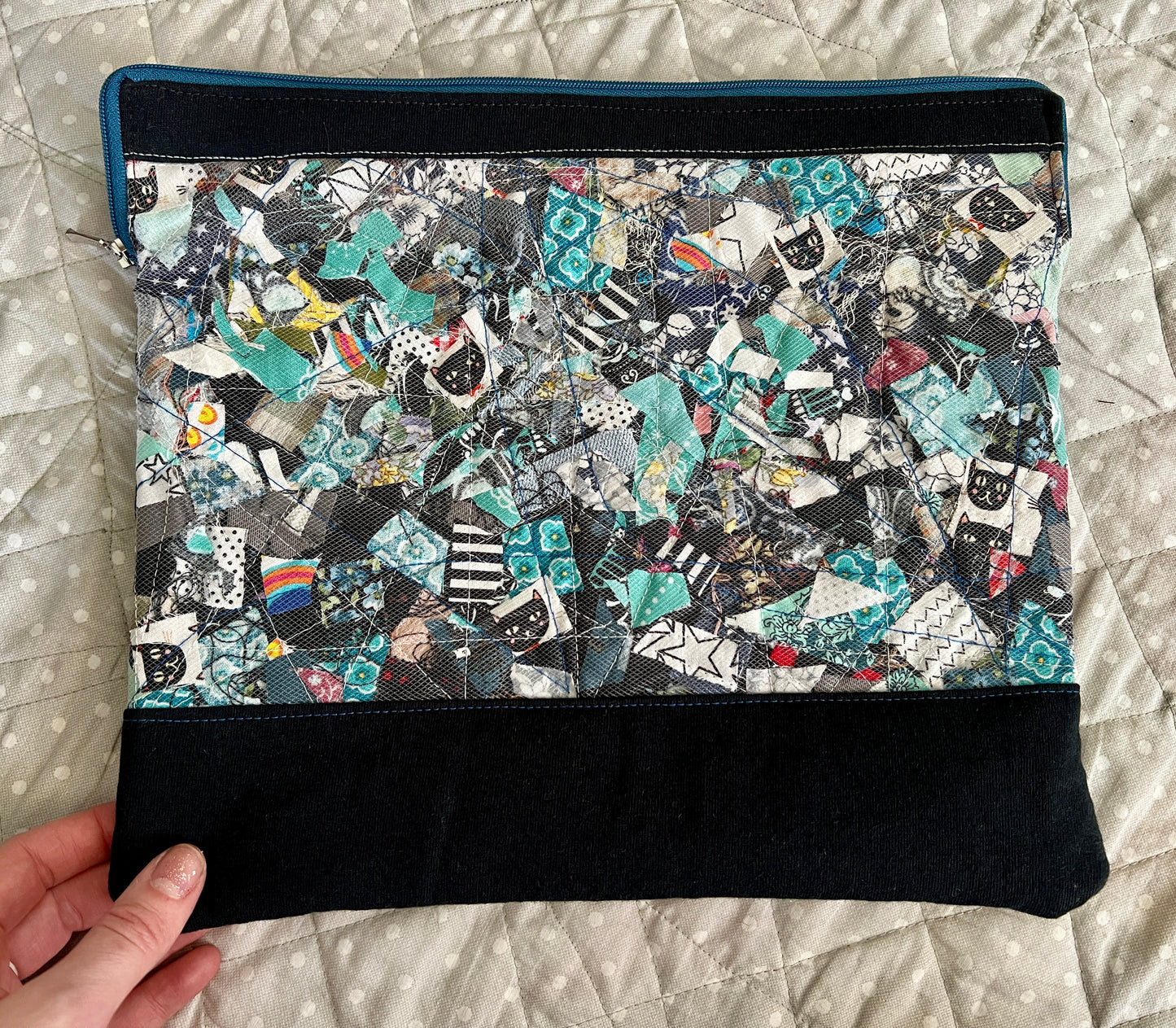ipad case held in the corner for scale, against a polkadot quilt background
