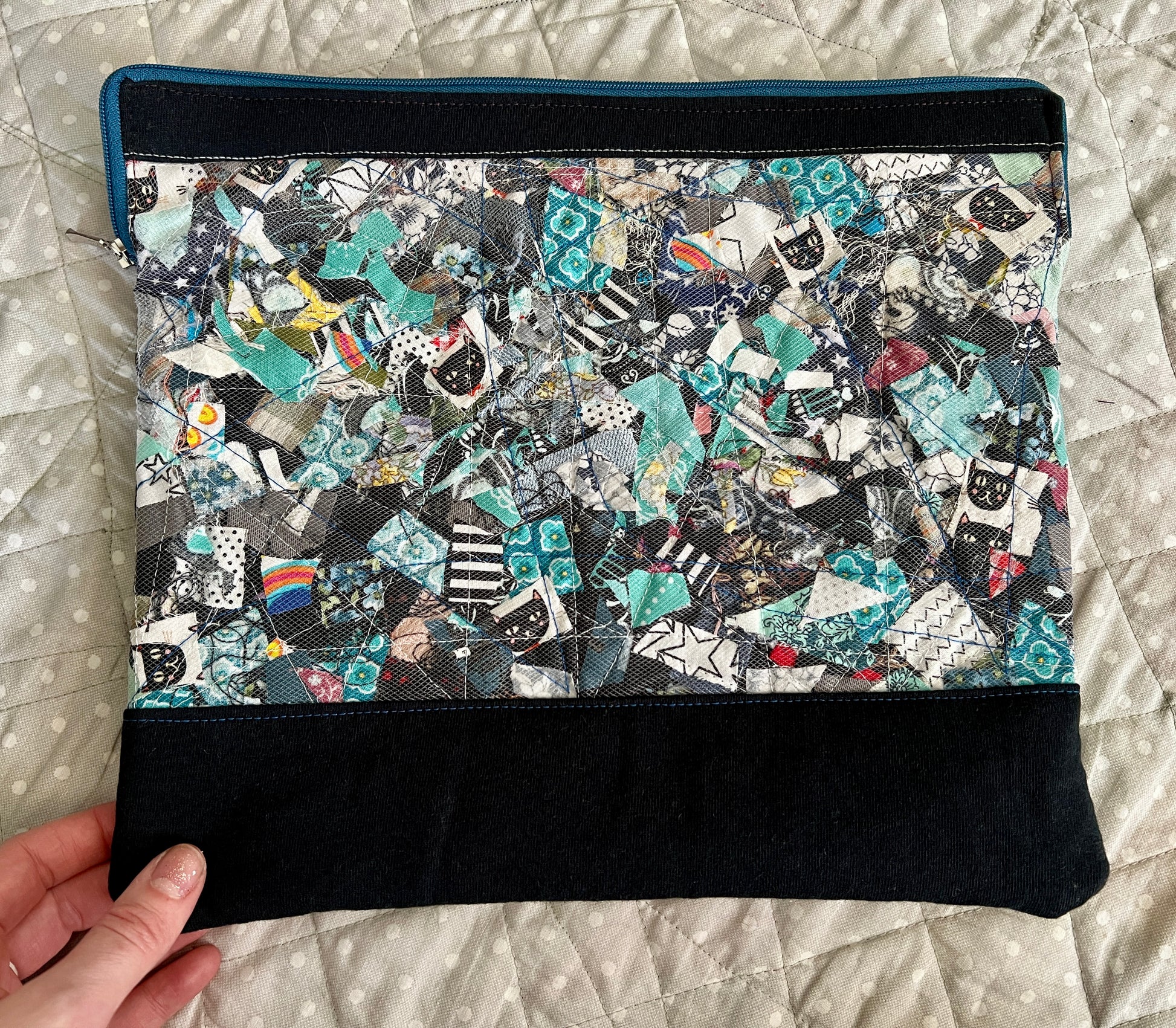 ipad case held in the corner for scale, against a polkadot quilt background