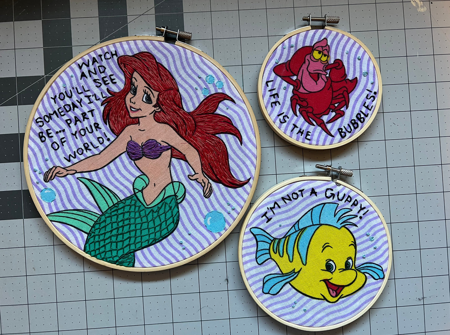 All three hoops from a vintage The Little Mermaid sheet, with quotes embroidered around the characters