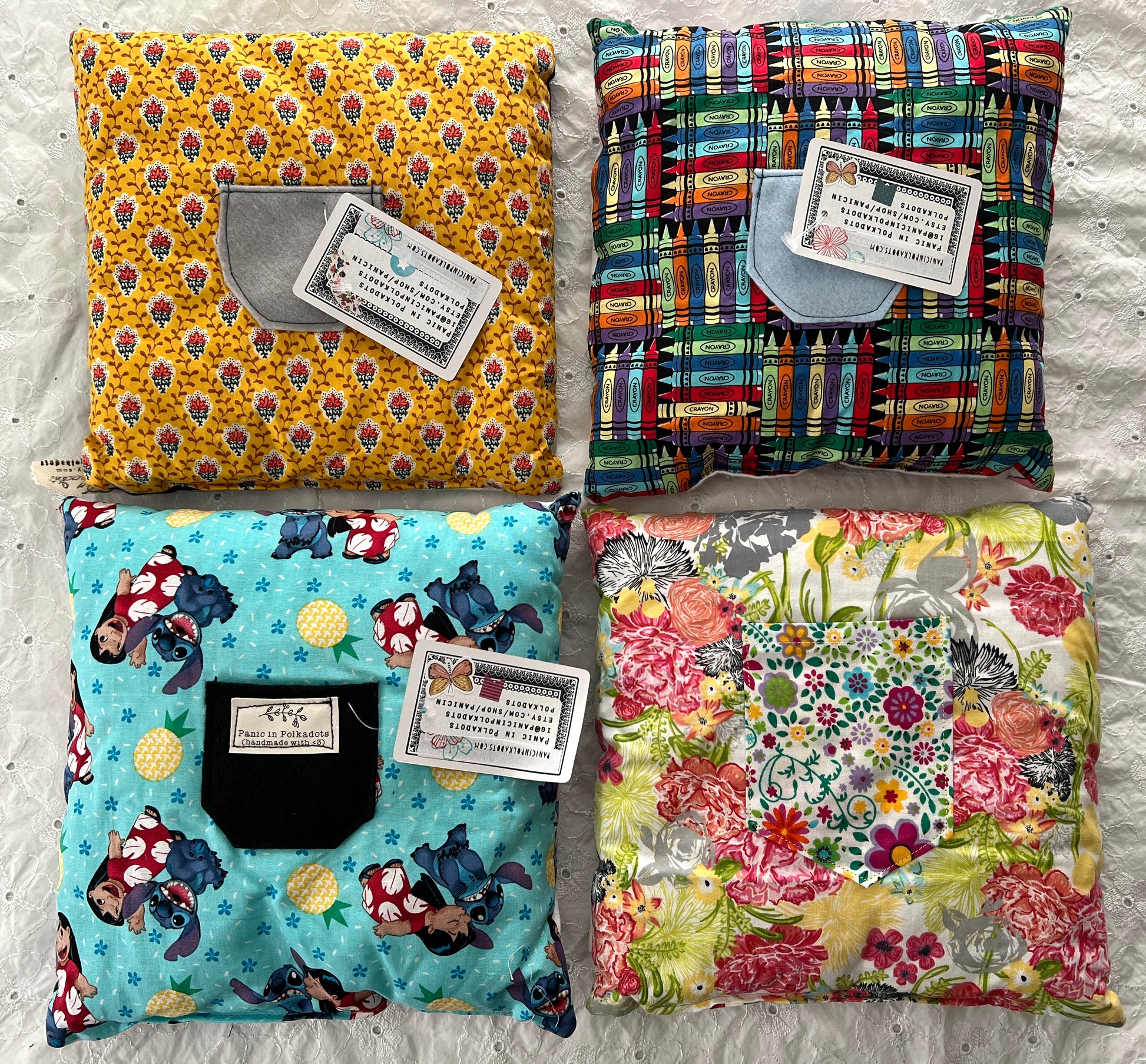 A group photo of little pillows showing the pocket on back for tooth fairy