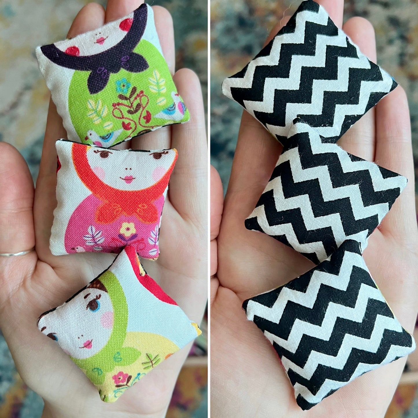 Small fabric pillows with colorful designs held in hands.