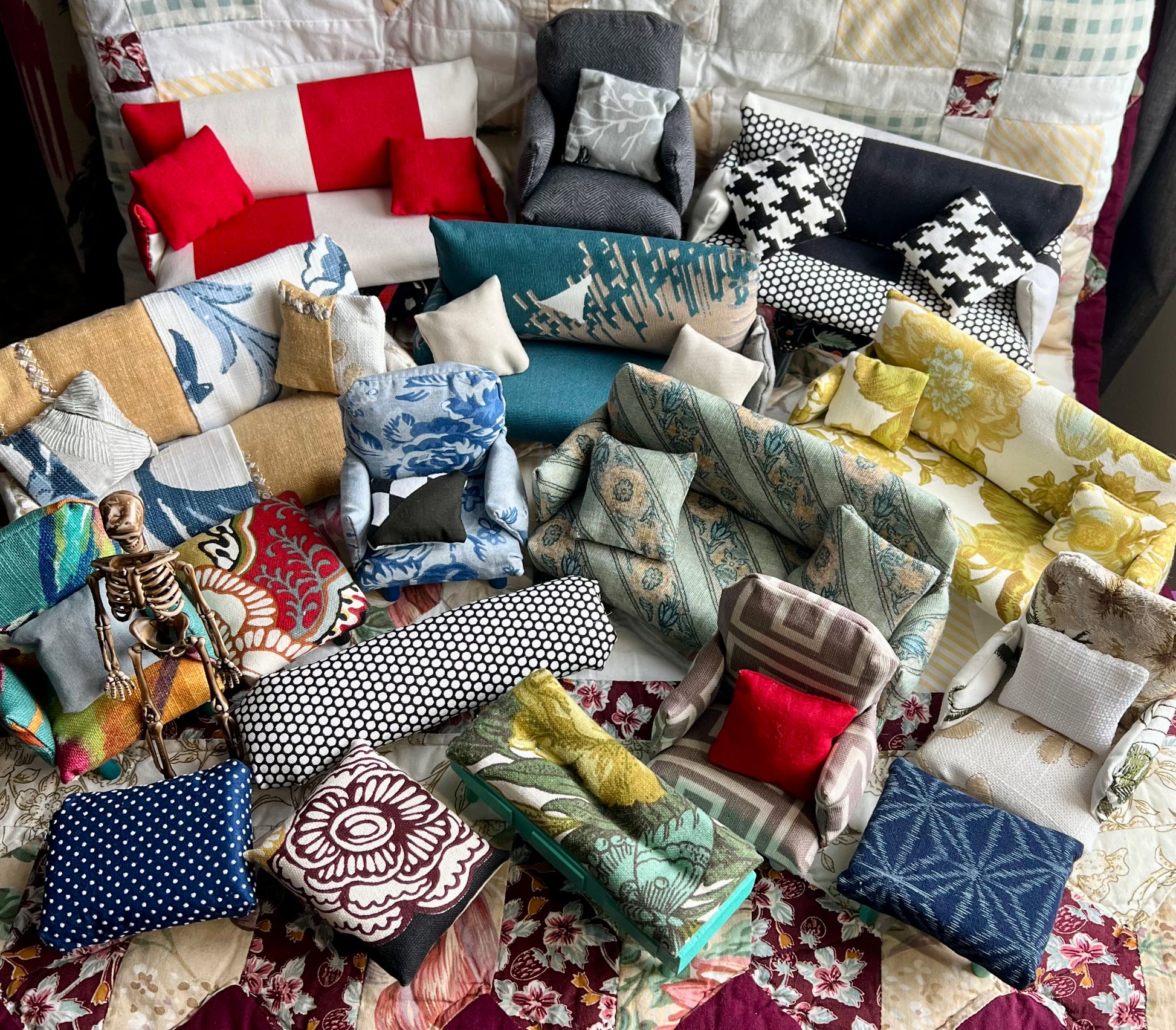 Collection of various miniature couches, chairs, and ottomans. 6 inch skeleton guy for scale