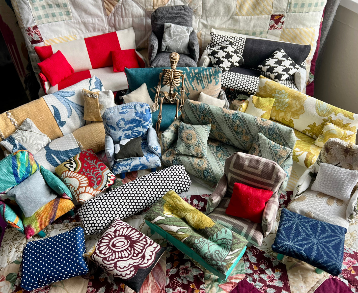 Collection of various miniature couches, chairs, and ottomans. 6 inch skeleton guy for scale