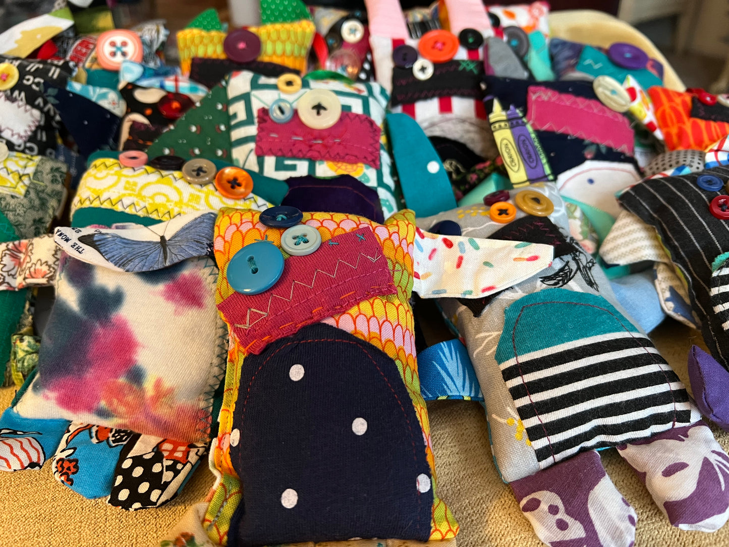 Collection of colorful fabric monsterfriends with various patterns and designs.