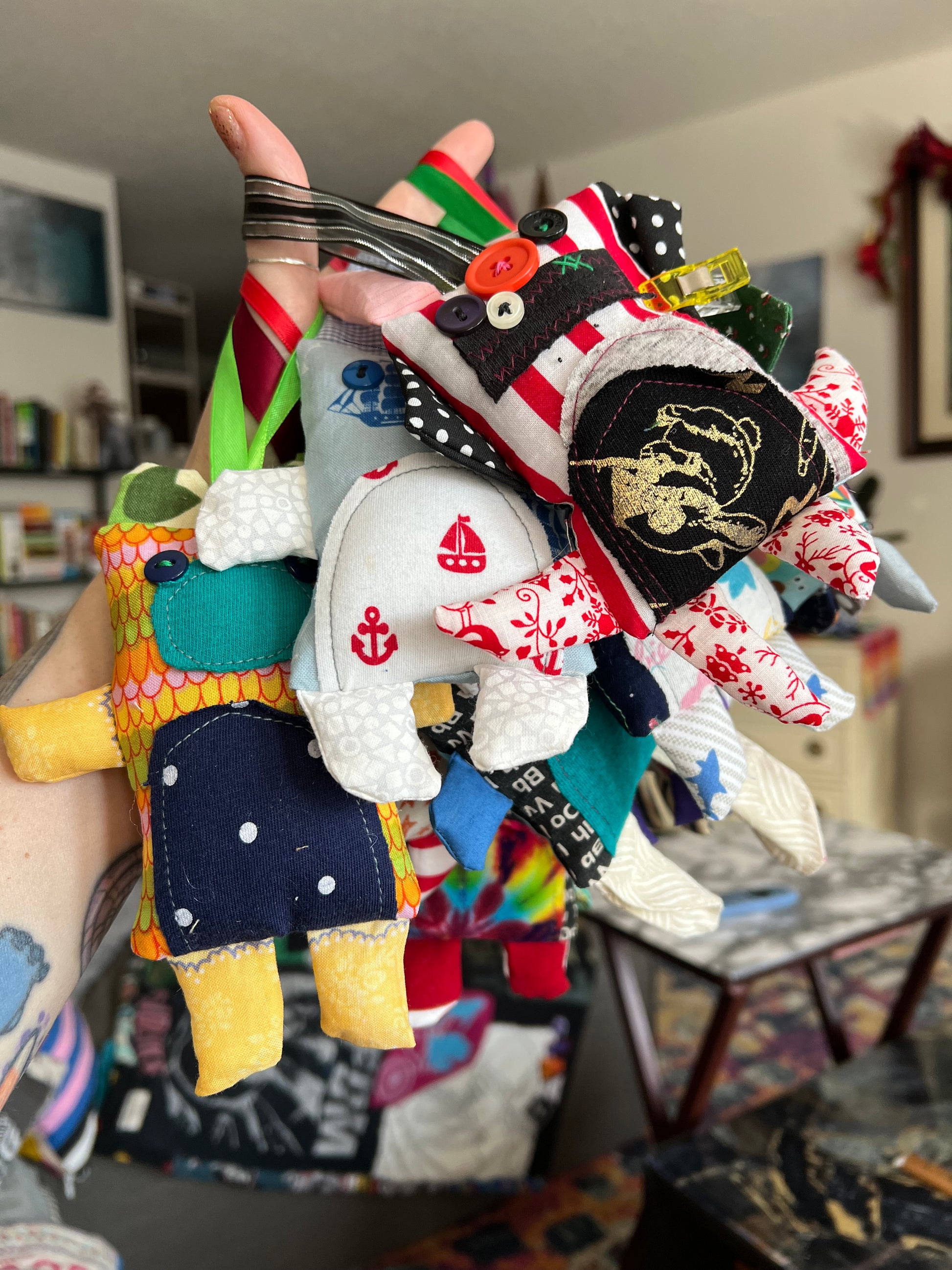 Colorful plush toy resembling a character with various patterns and designs.