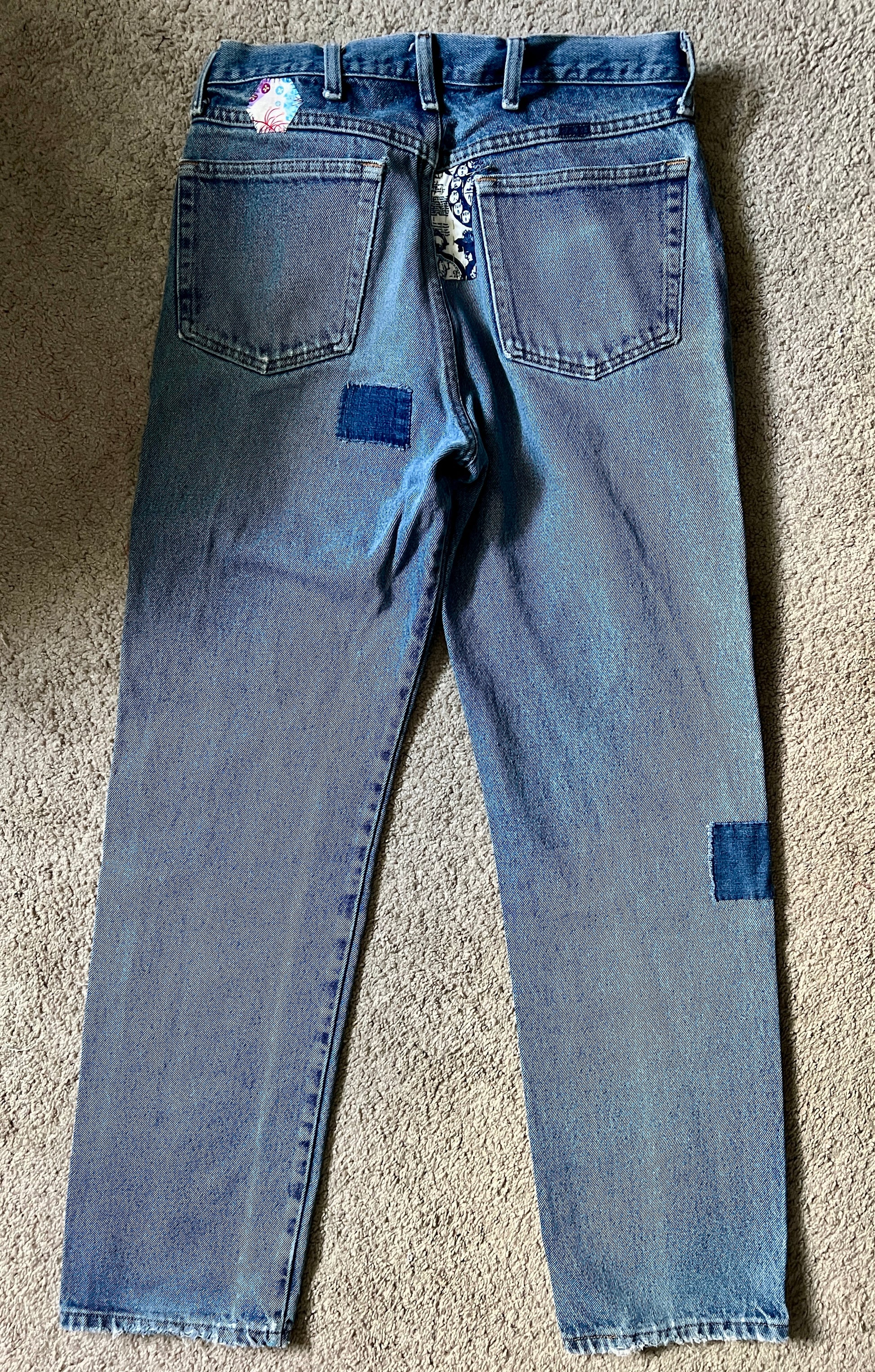 Panic clothing, denim jeans with blue advertisement fabric added to prolong their life