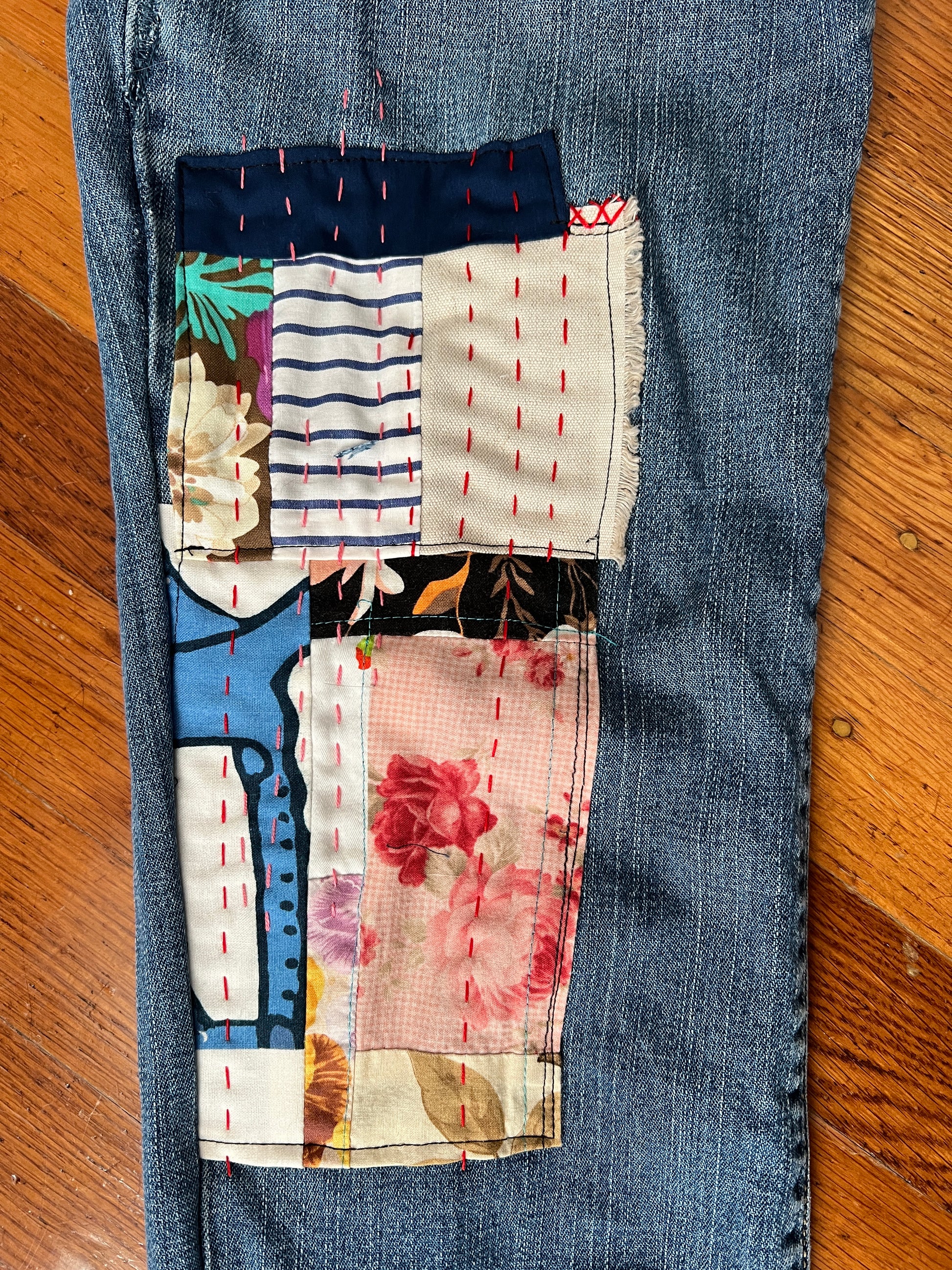 Panic clothing, denim jeans with floral and stripes fabric added to prolong their life