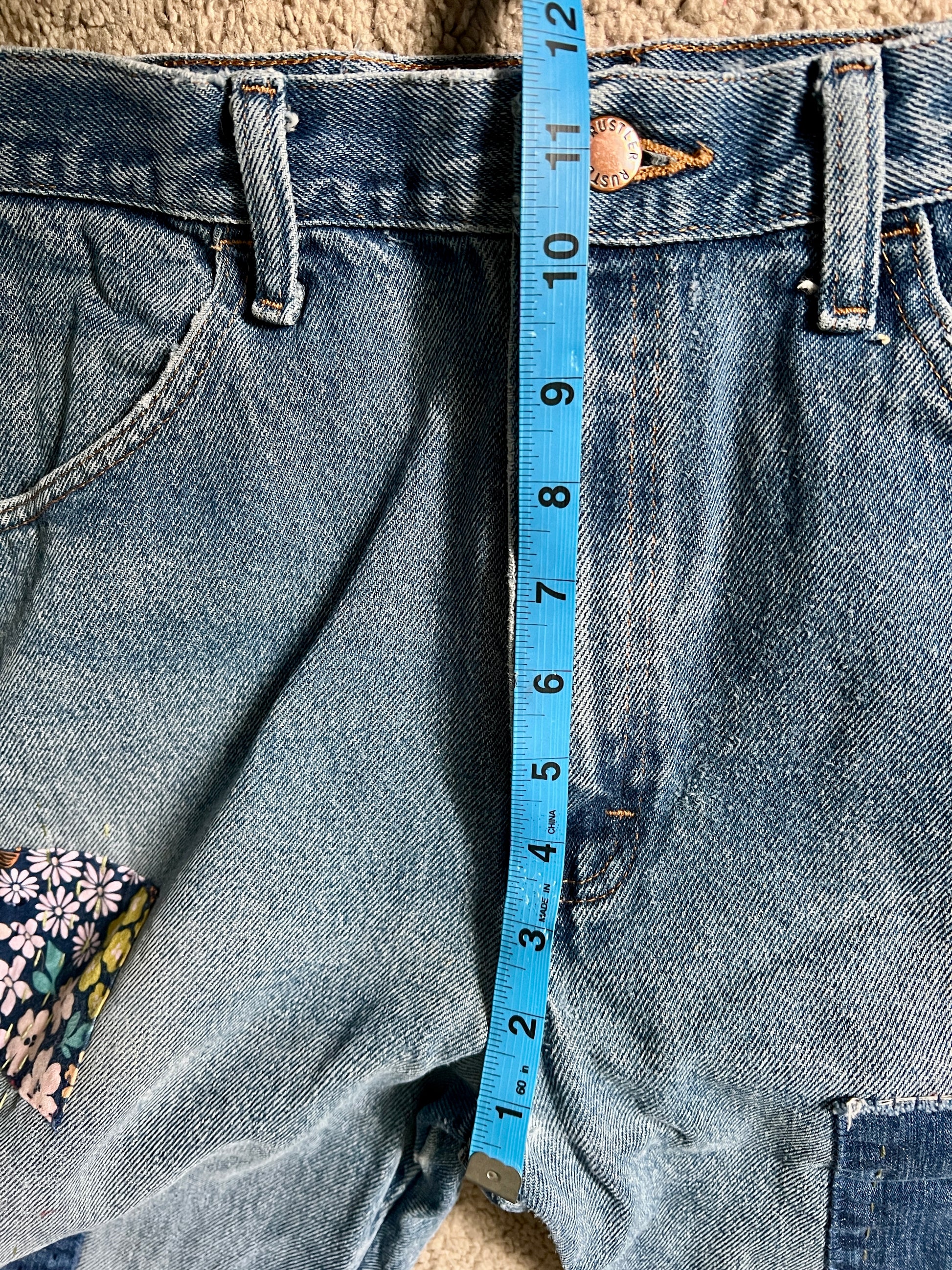 Panic clothing, denim jeans with blue advertisement fabric added to prolong their life