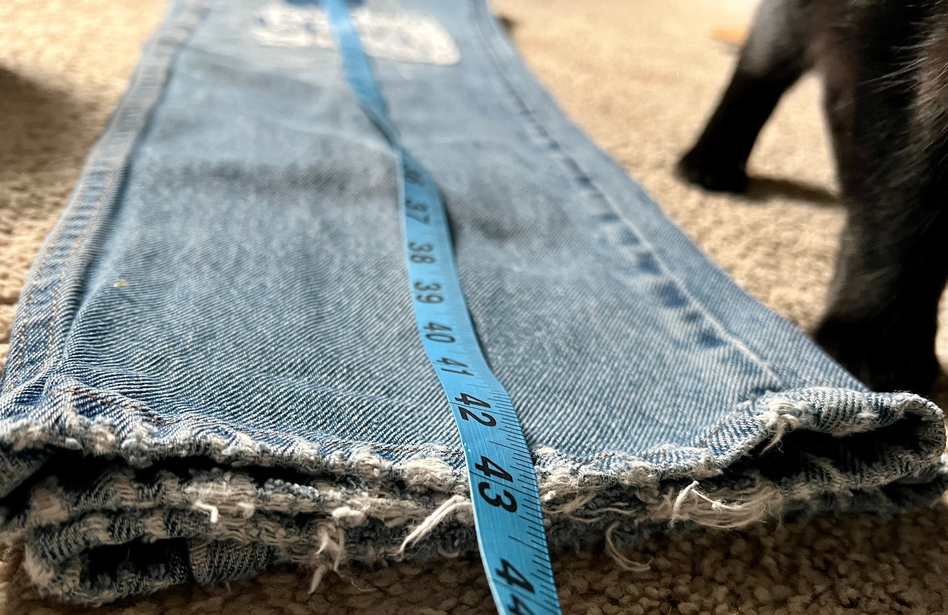 Panic clothing, denim jeans with blue advertisement fabric added to prolong their life