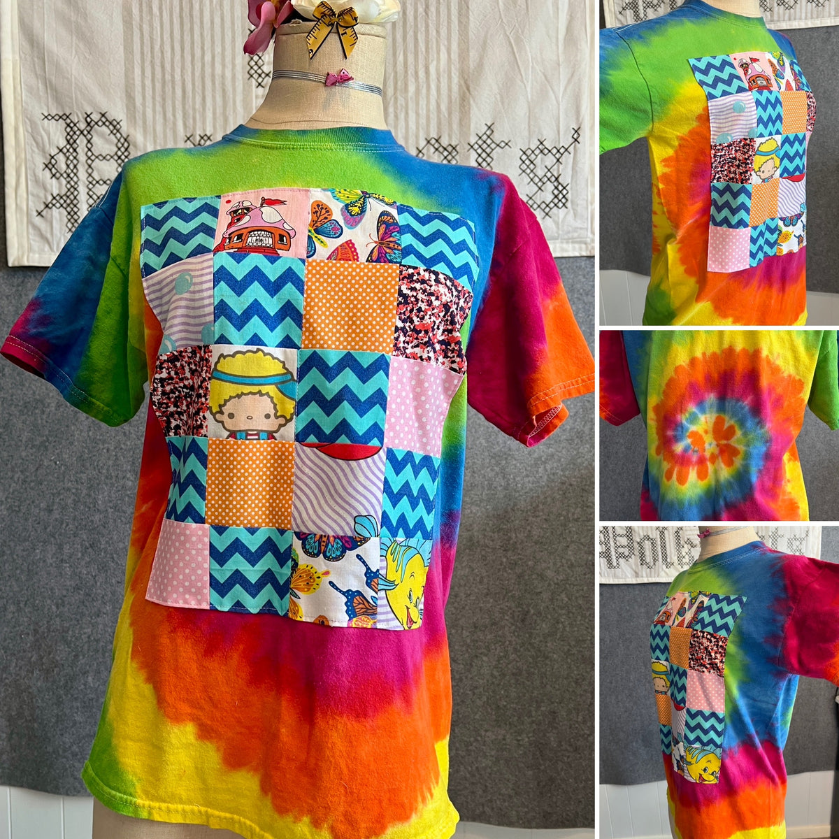 Quilty tee shirt with tie dye design, characters, polkadots, and chevron designs in a patchwork quilt on front.
