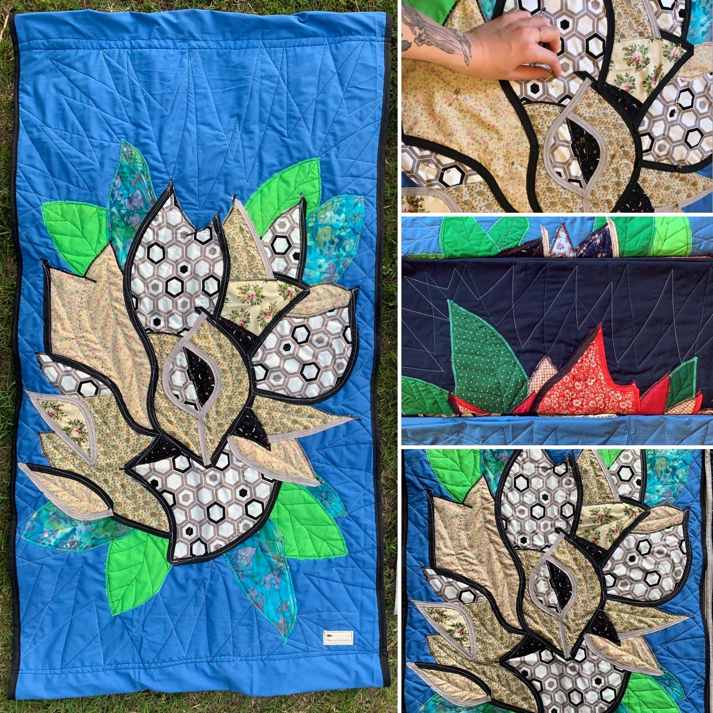 Quilt with floral rose applique design on a blue background, showing close-up details.