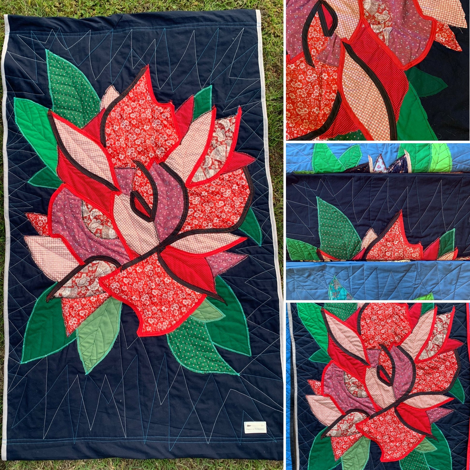 Floral quilt with red and green rose design on a dark blue background