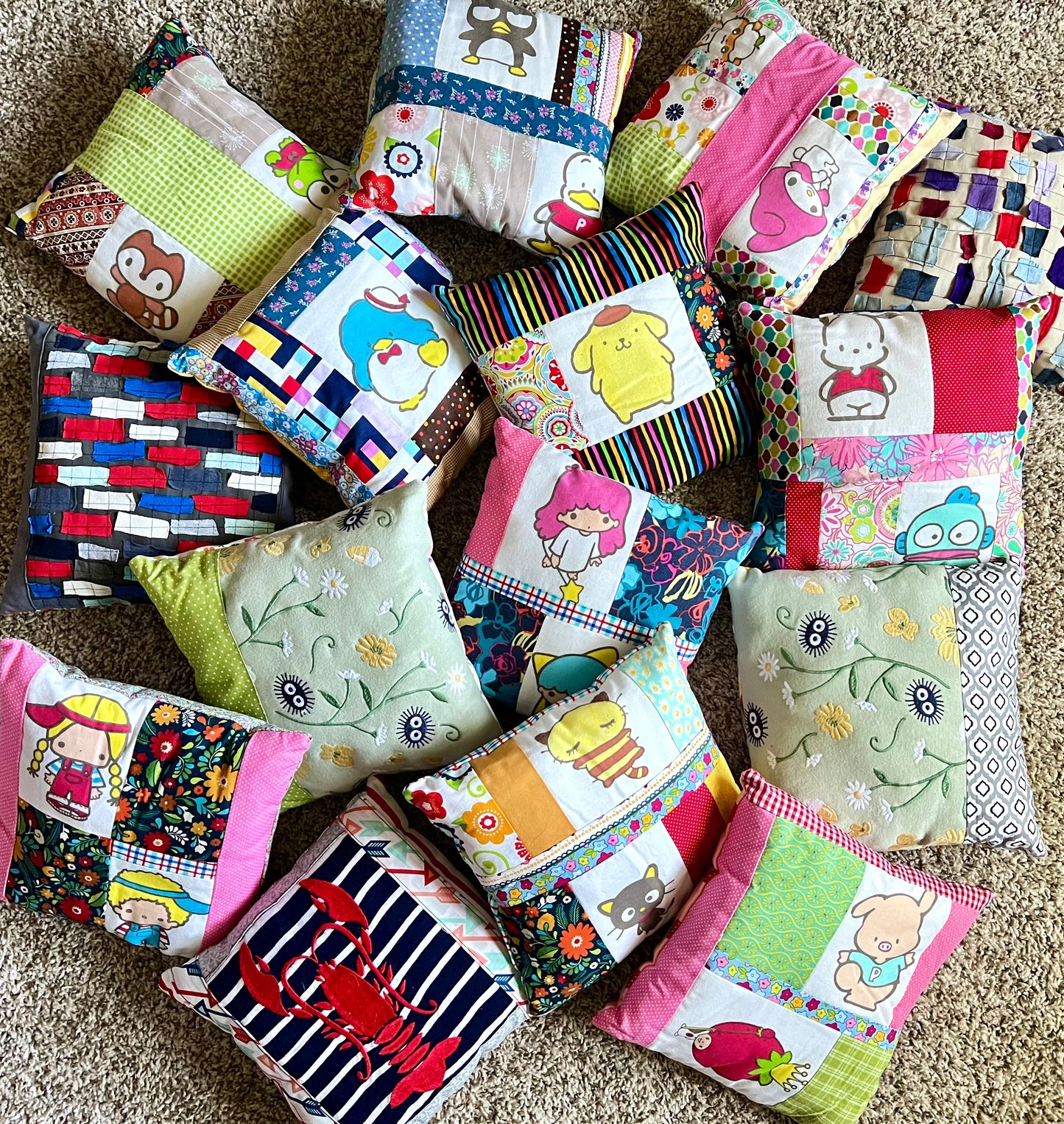 A collection of handmade patchwork pillows in various colorful patterns and designs, arranged on a beige background.