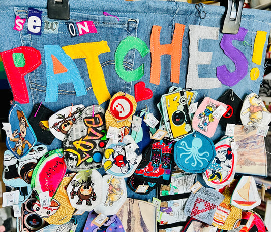 Collection of colorful patches on a denim background with 'Sew On Patches!' text.