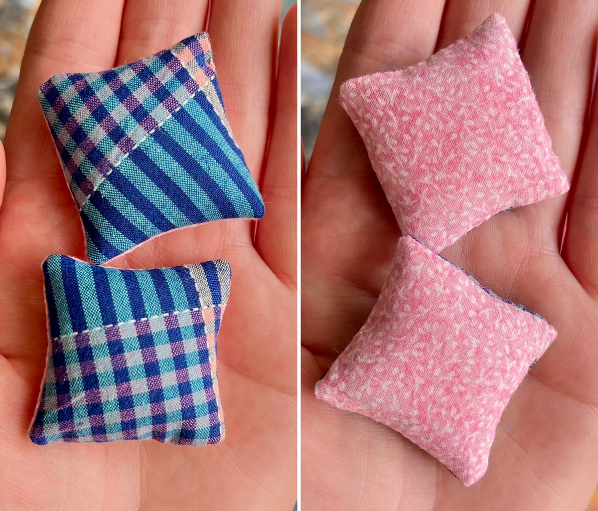 Two small fabric pillows, one blue and plaid, one pink with white pattern, held in a hand.