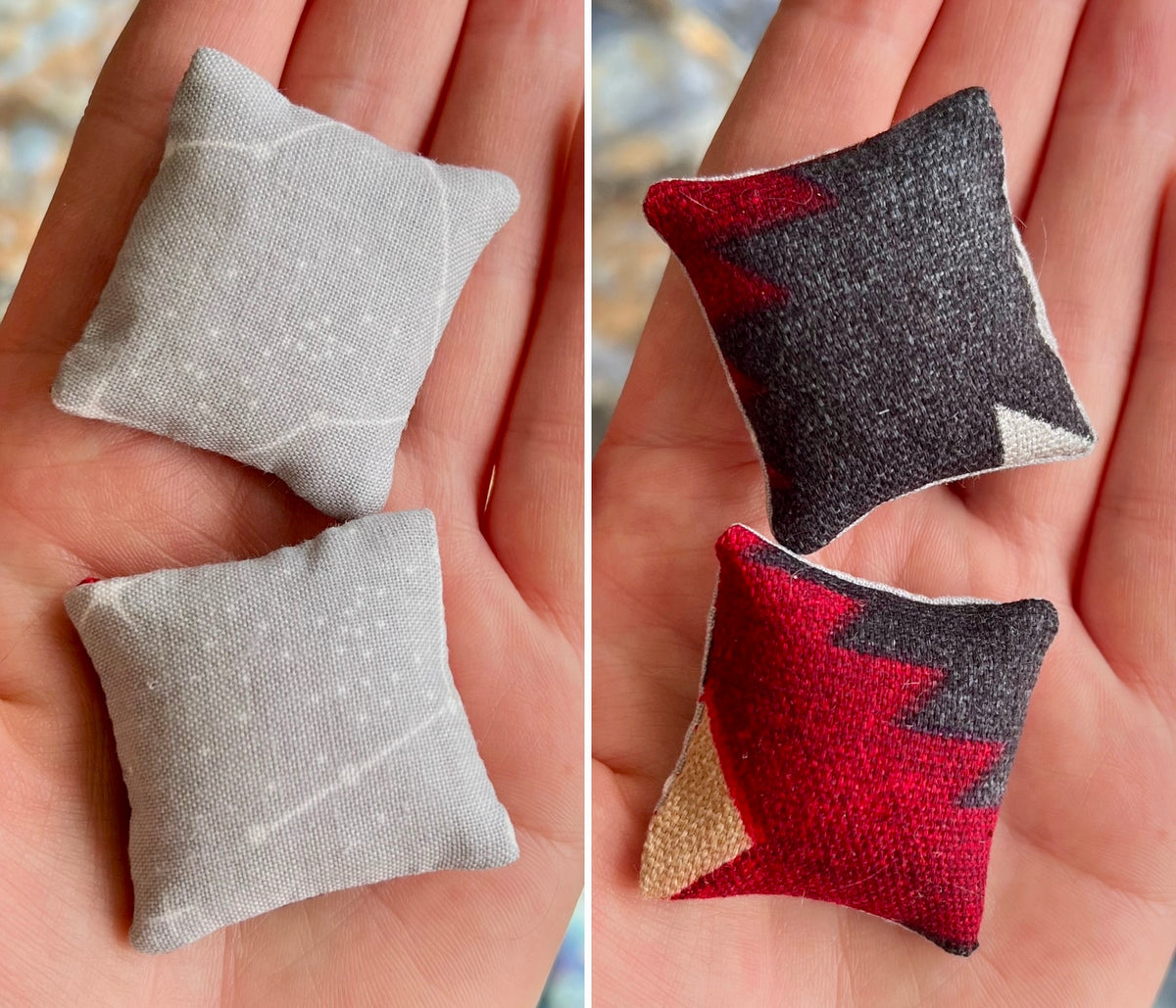 Two small fabric pillows, front gray and back with red and black pattern, held in hands.
