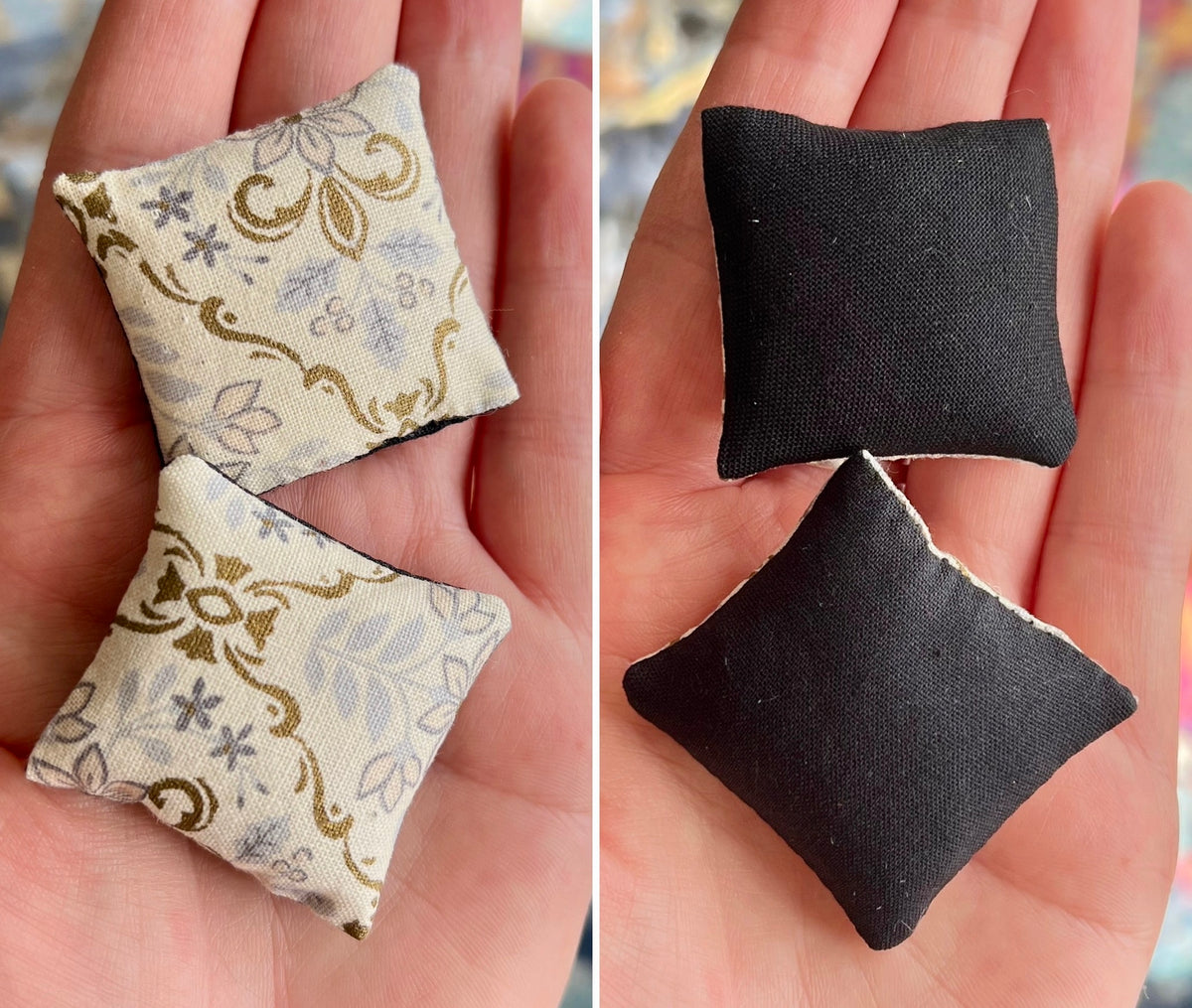 Two sets of small fabric pillows, front with floral pattern and back plain black, held in hands.